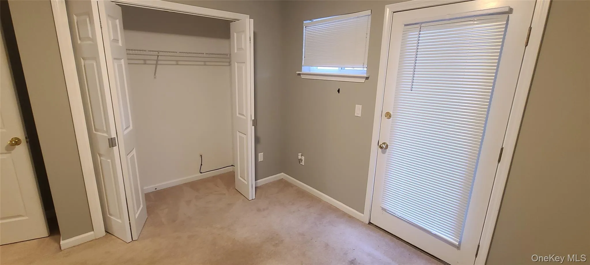 Door to balcony/ covered deck area from bedroom Door to balcony/ covered deck area from bedroom