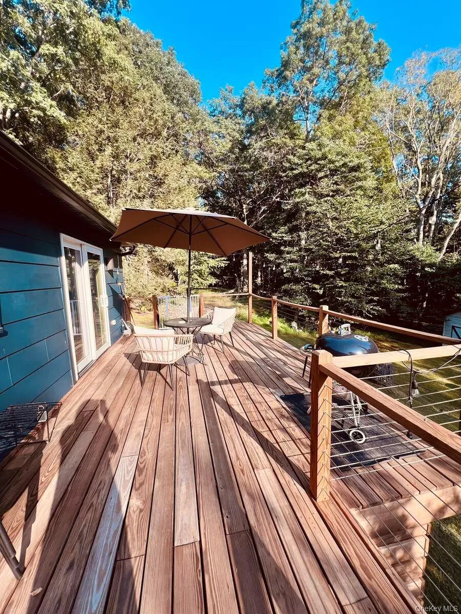 Wooden terrace featuring outdoor dining area Wooden terrace featuring outdoor dining area