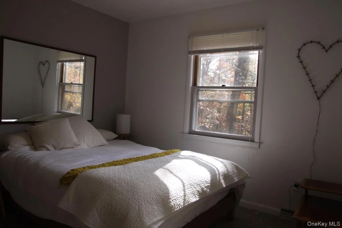 Bedroom with baseboards and carpet Bedroom with baseboards and carpet