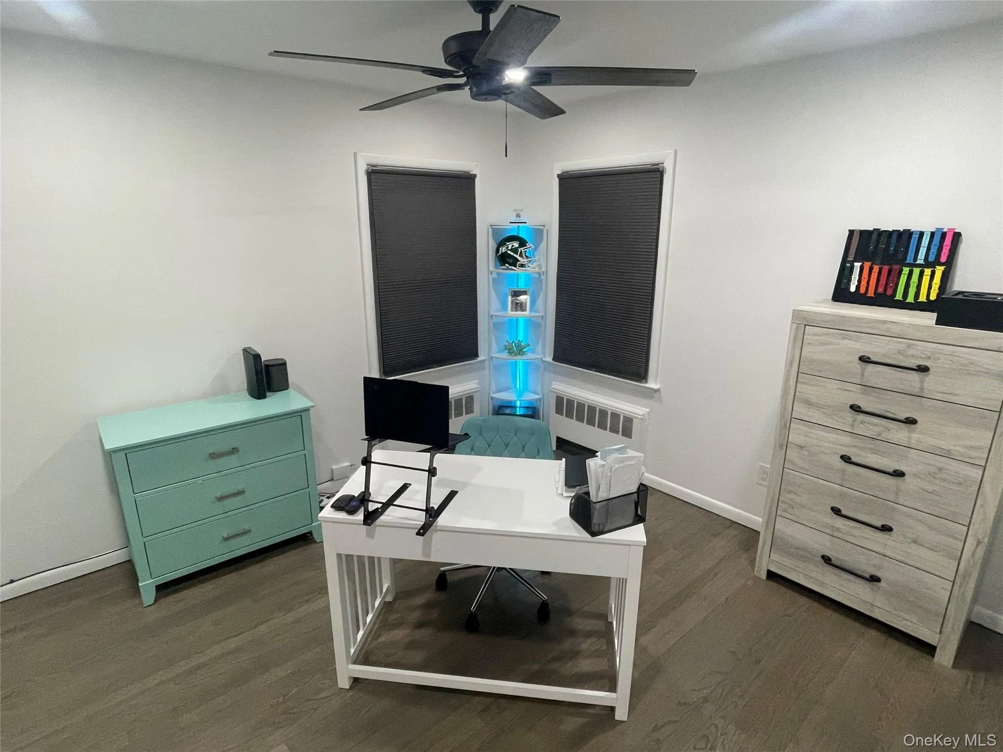 Office space with dark wood-type flooring and ceiling fan Office space with dark wood-type flooring and ceiling fan