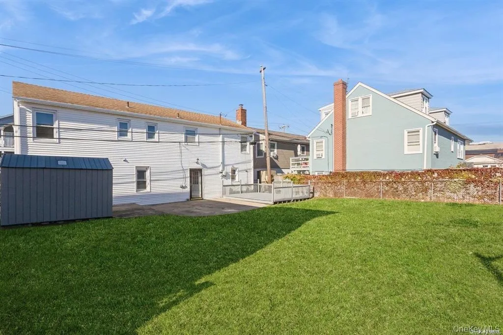 Rear view of property with a patio and a storage unit Rear view of property with a patio and a storage unit