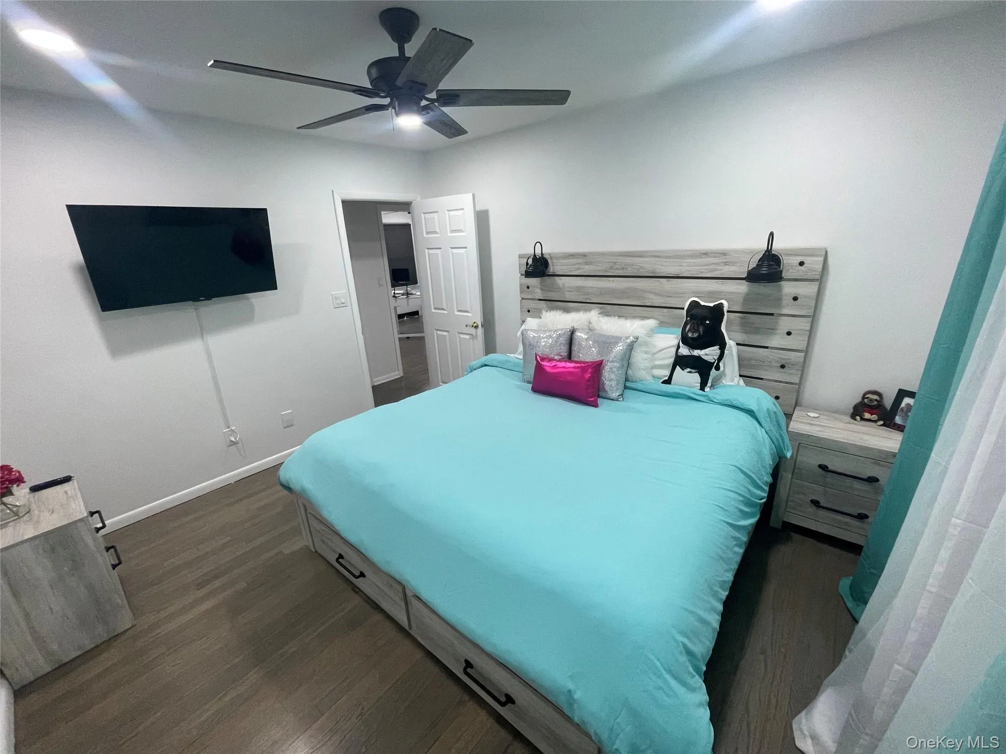 Bedroom featuring dark wood finished floors and a ceiling fan Bedroom featuring dark wood finished floors and a ceiling fan