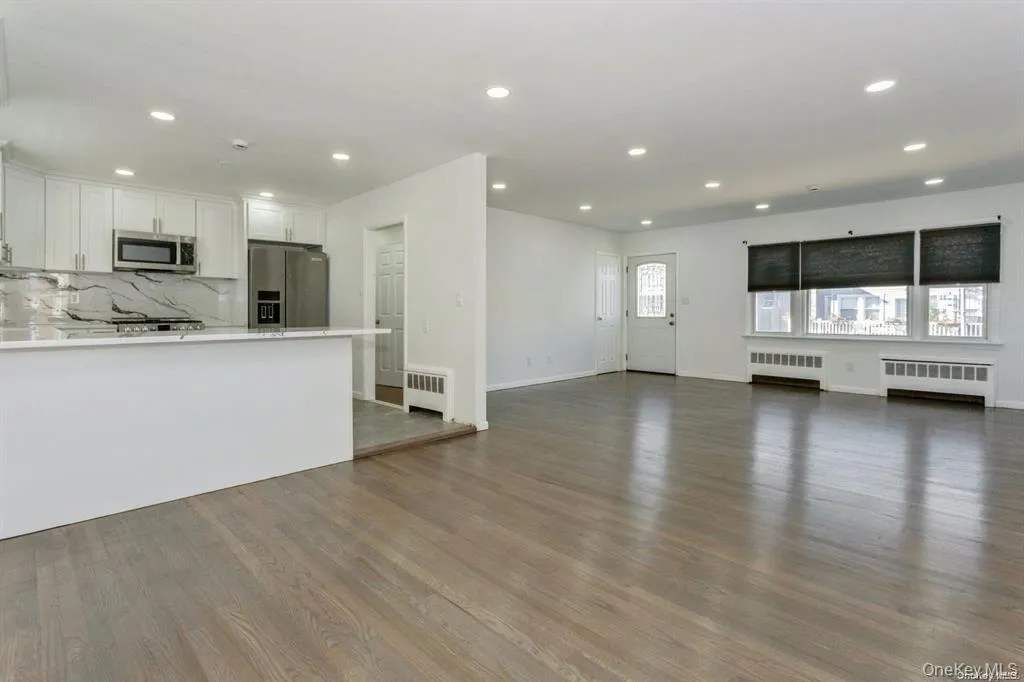 living room with wood flooring, and recessed lighting living room with wood flooring, and recessed lighting