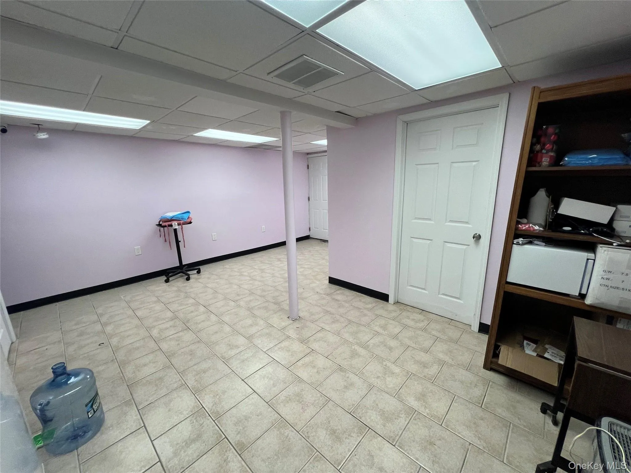 Finished below grade area with a paneled ceiling and light tile patterned floors Finished below grade area with a paneled ceiling and light tile patterned floors