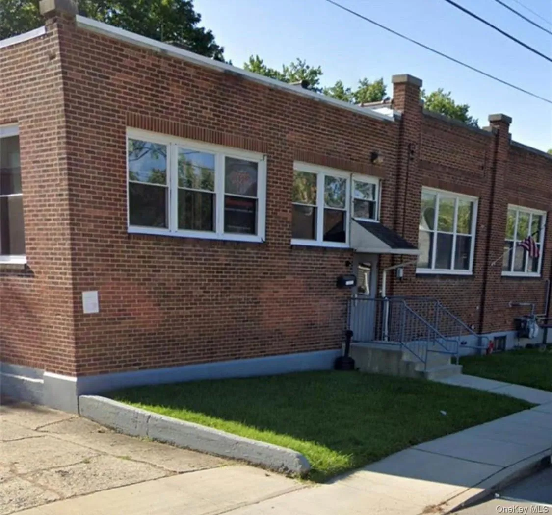 View of front of house with a front yard and brick siding View of front of house with a front yard and brick siding