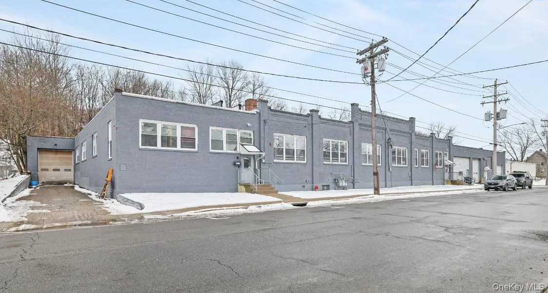 View of front of house with entry steps, a garage, and brick siding View of front of house with entry steps, a garage, and brick siding