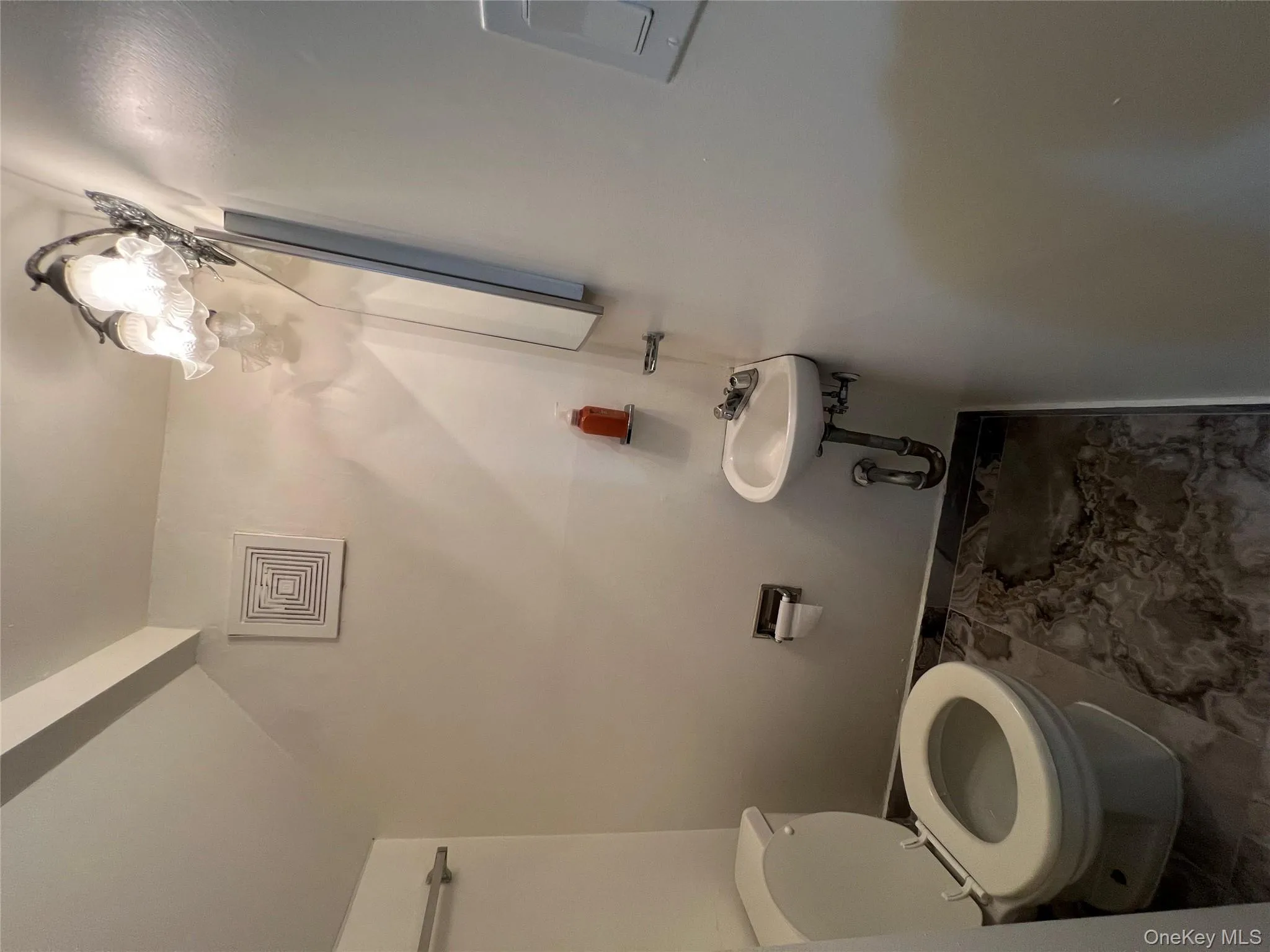 Half bath featuring toilet and baseboards Half bath featuring toilet and baseboards