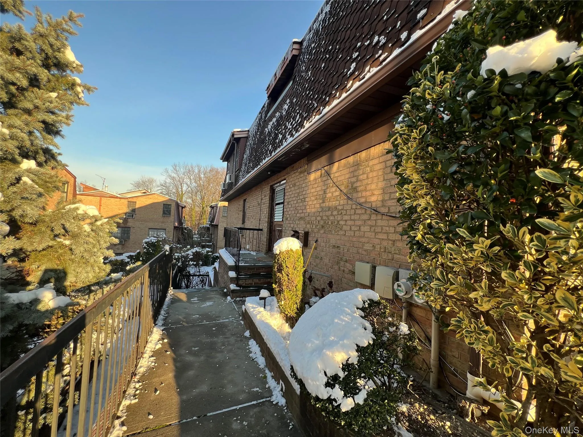 View of side of home with brick siding and a wooden deck View of side of home with brick siding and a wooden deck