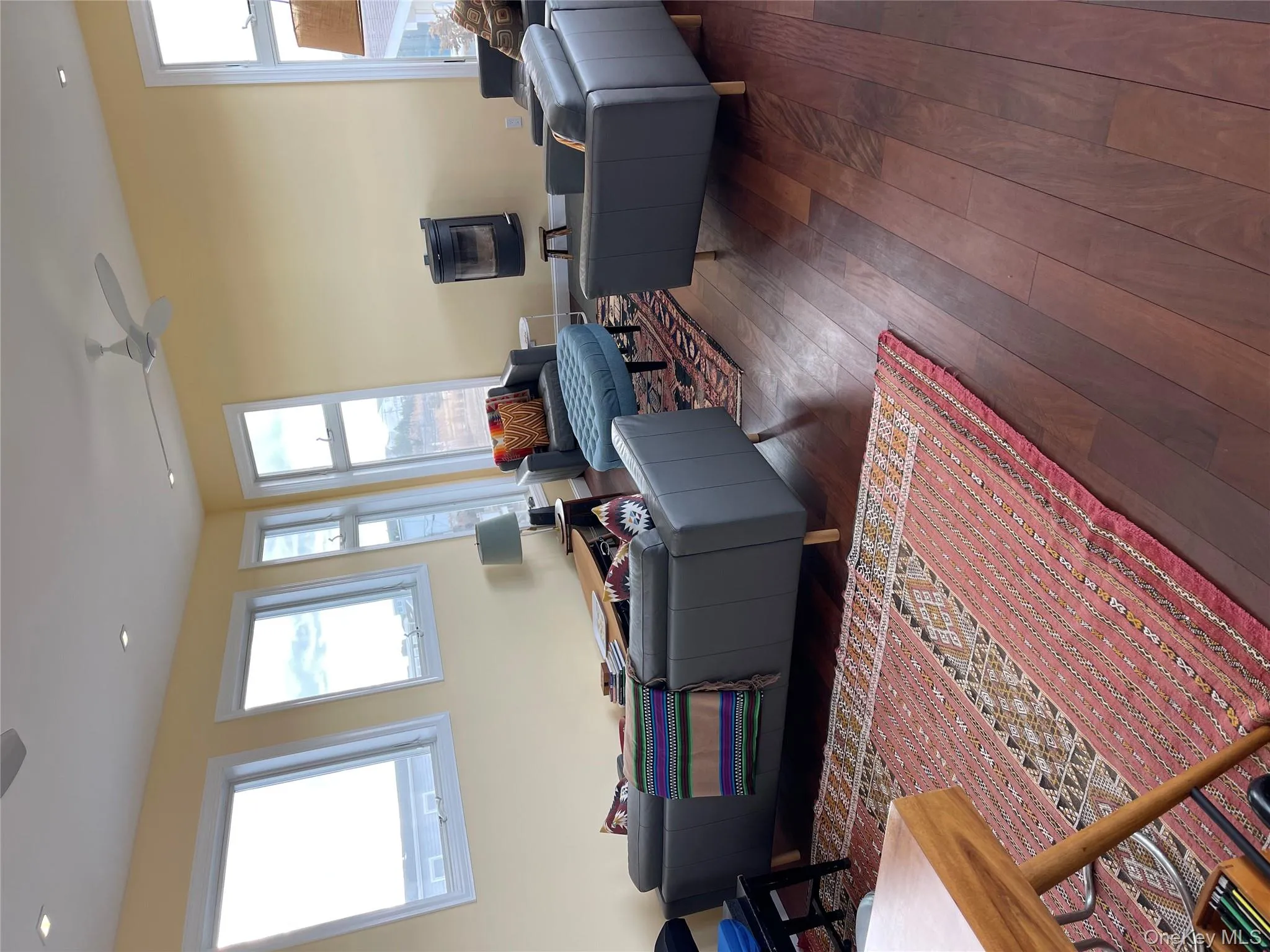 Living room featuring dark wood-type flooring and ceiling fan Living room featuring dark wood-type flooring and ceiling fan