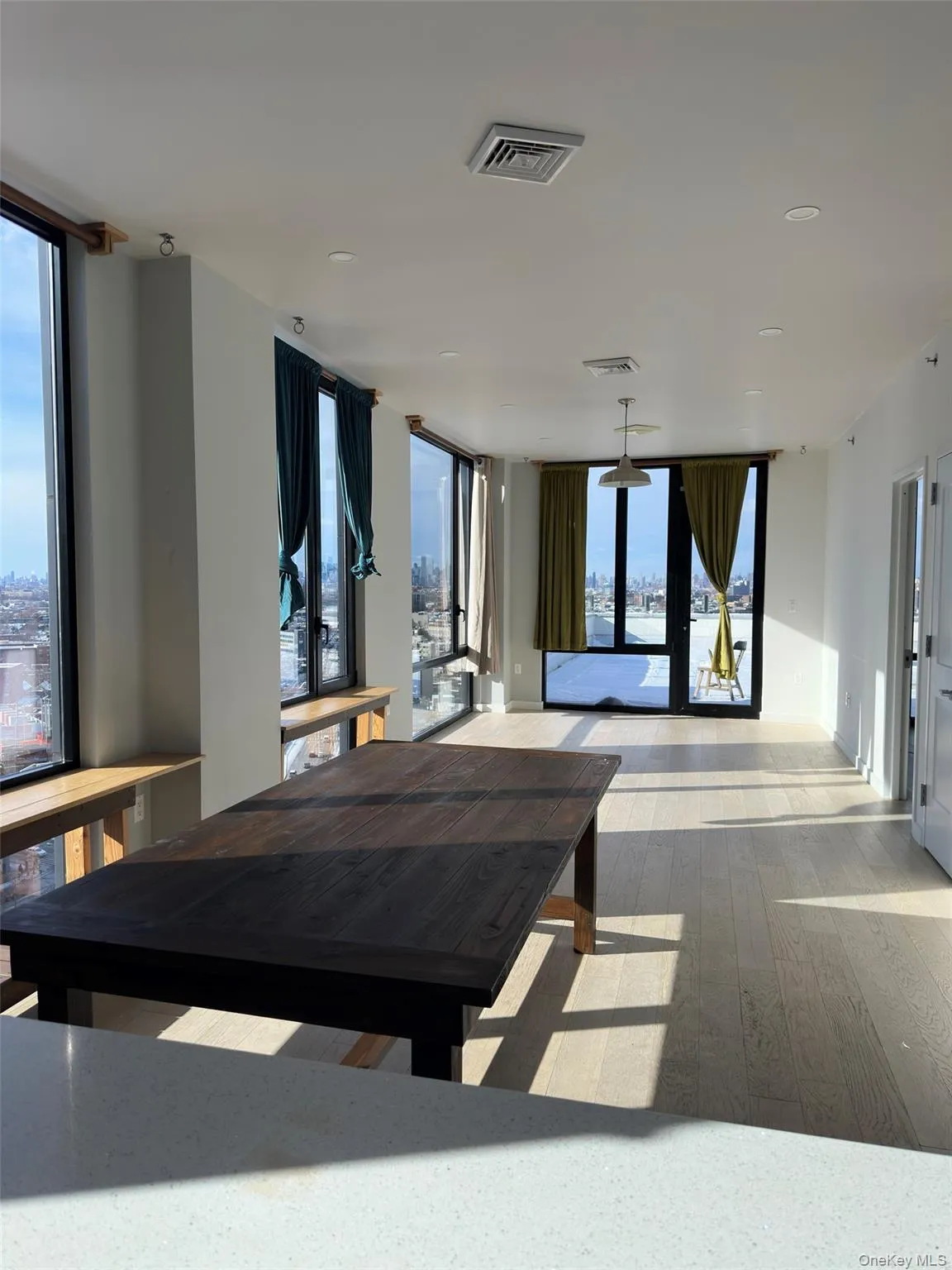 Dining area with french doors, a wall of windows, and hardwood / wood-style floors Dining area with french doors, a wall of windows, and hardwood / wood-style floors