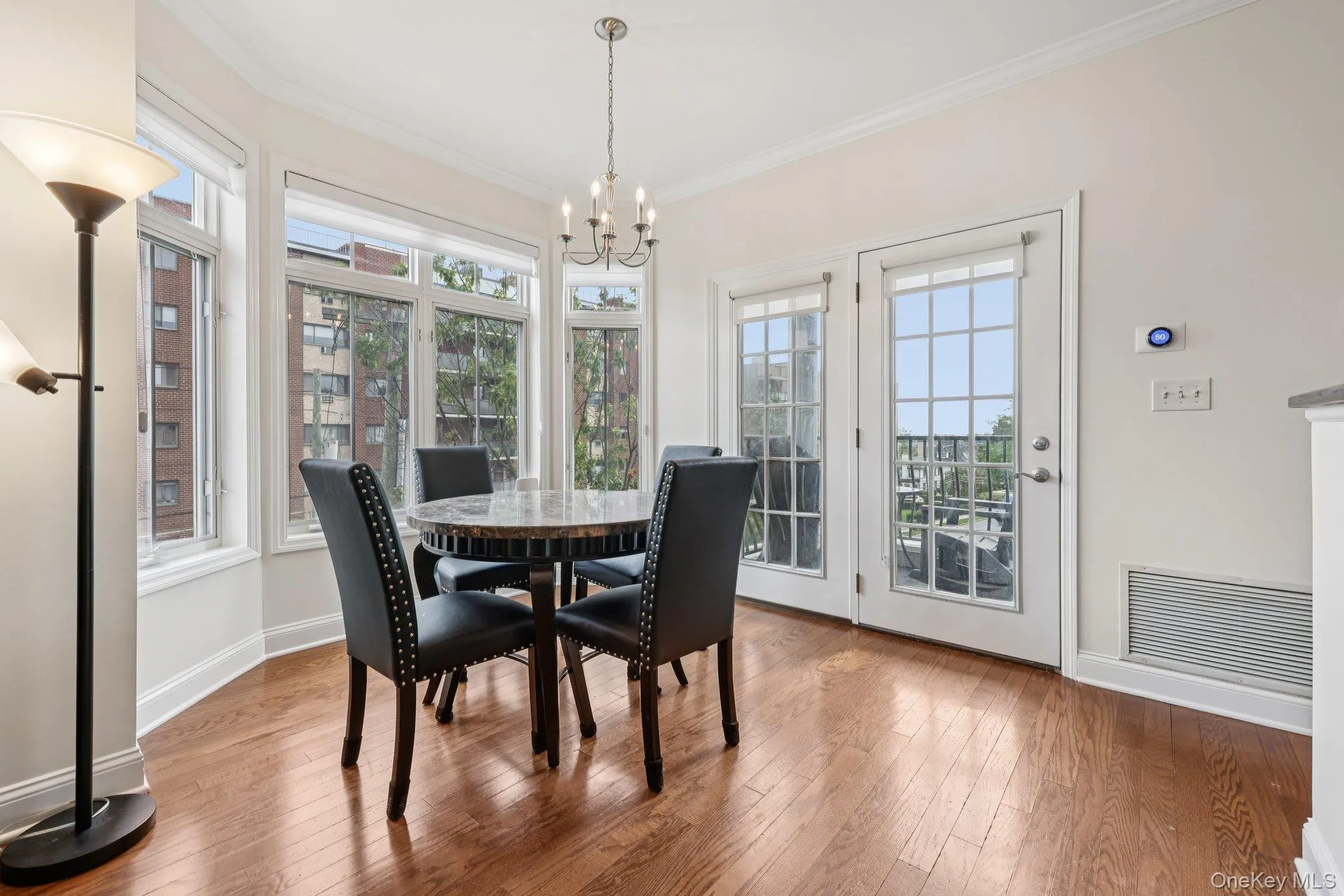 Dining area with large windows and easy access to patio Dining area with large windows and easy access to patio
