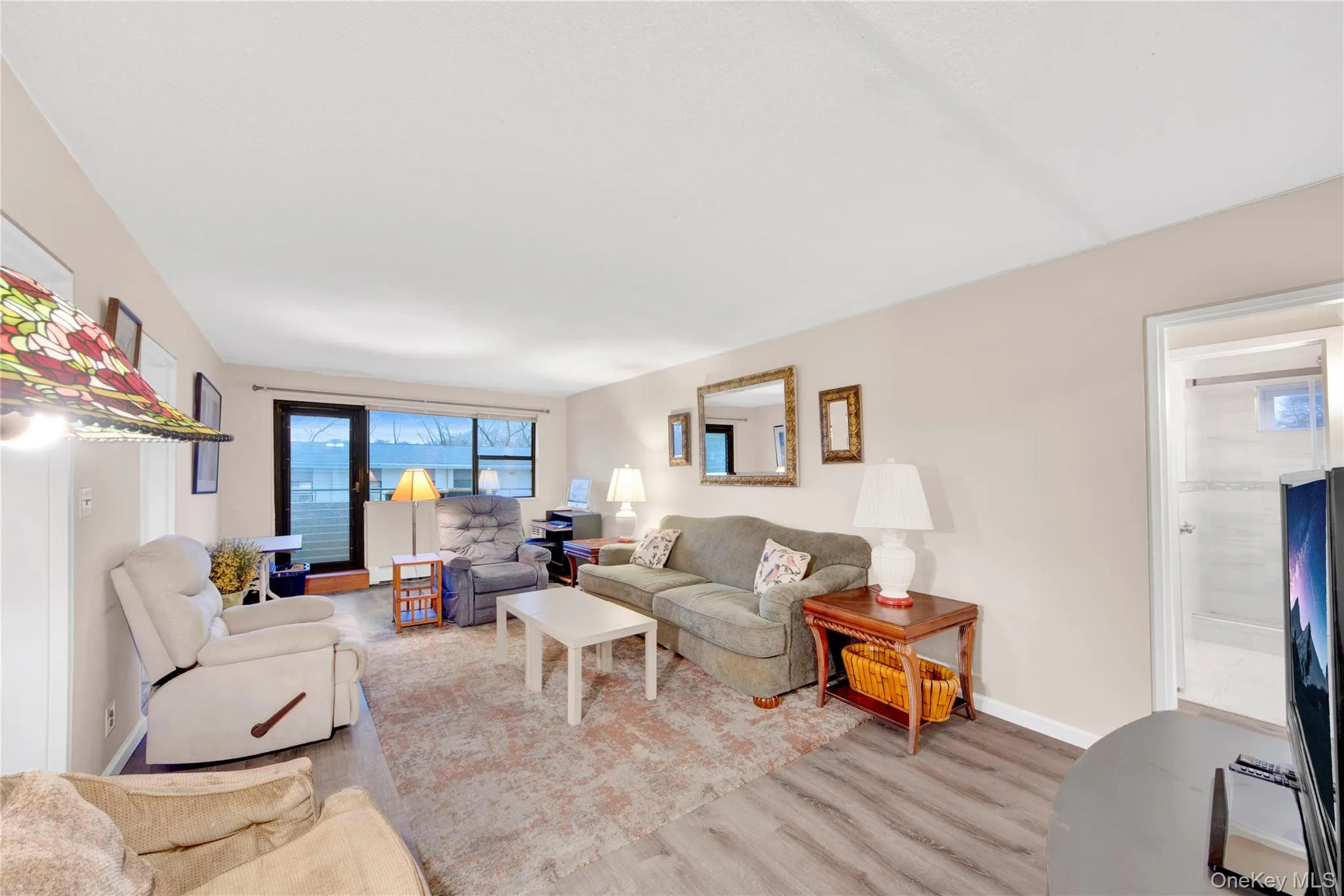 Living room featuring wood finished floors and baseboards Living room featuring wood finished floors and baseboards