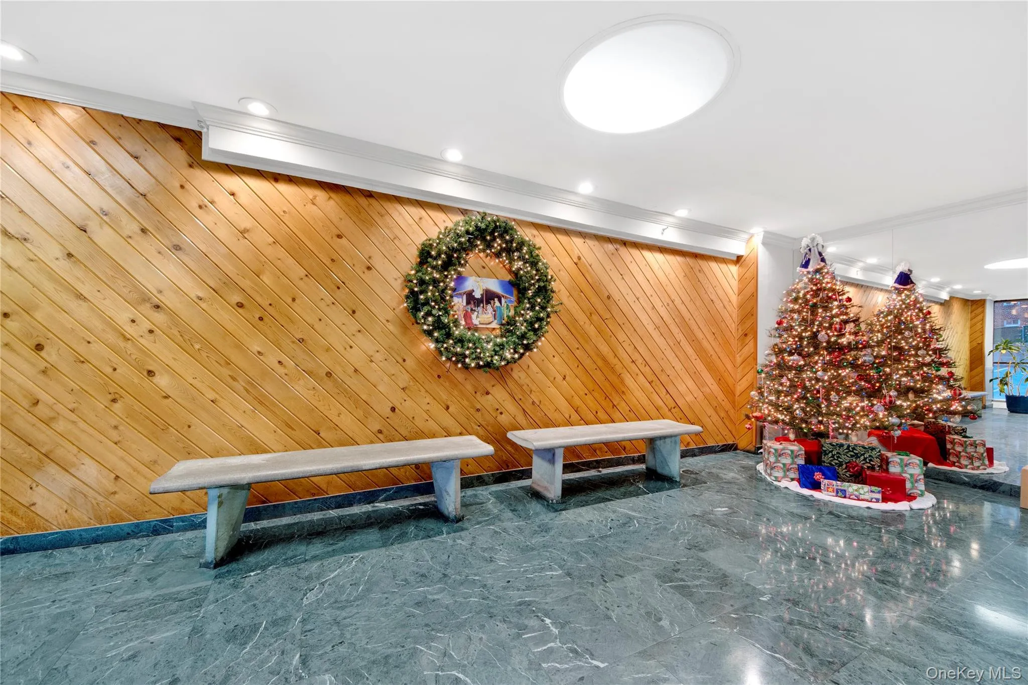 Building lobby featuring wooden walls, recessed lighting, and crown molding Building lobby featuring wooden walls, recessed lighting, and crown molding