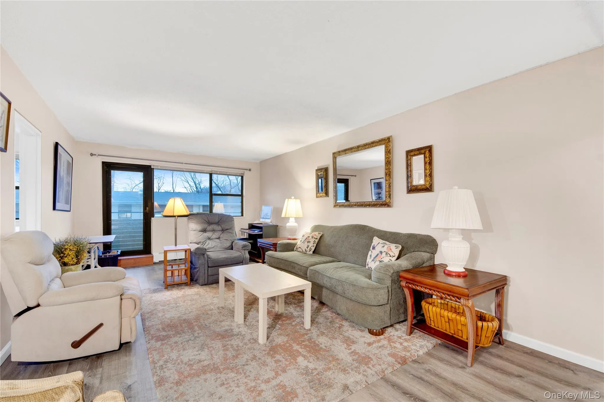 Living area featuring wood finished floors and baseboards Living area featuring wood finished floors and baseboards