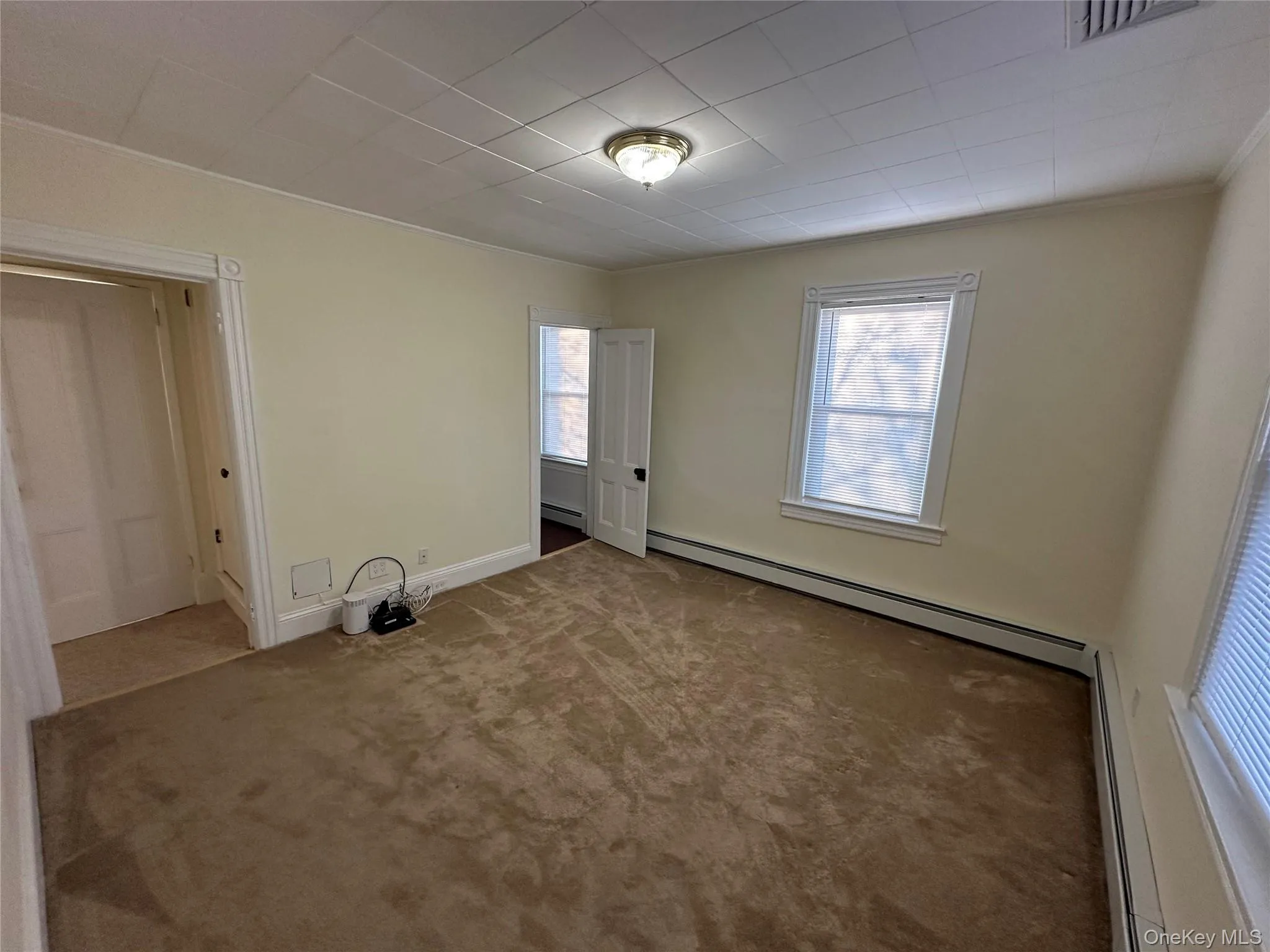 Another view with carpet and a baseboard heating unit Another view with carpet and a baseboard heating unit