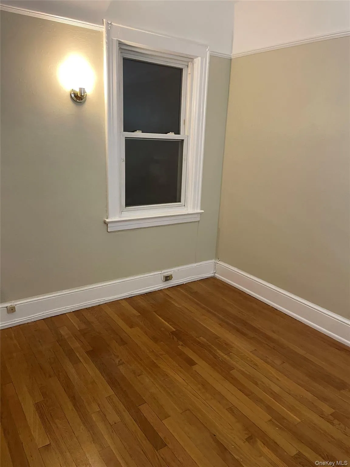 Empty room with dark wood-style floors and ornamental molding Empty room with dark wood-style floors and ornamental molding