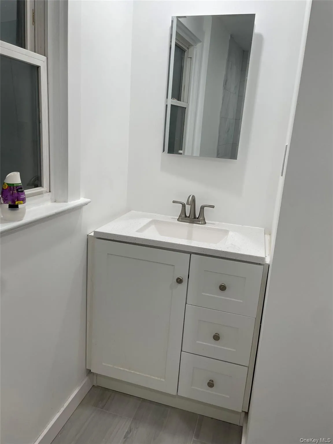 Bathroom featuring vanity and baseboards Bathroom featuring vanity and baseboards