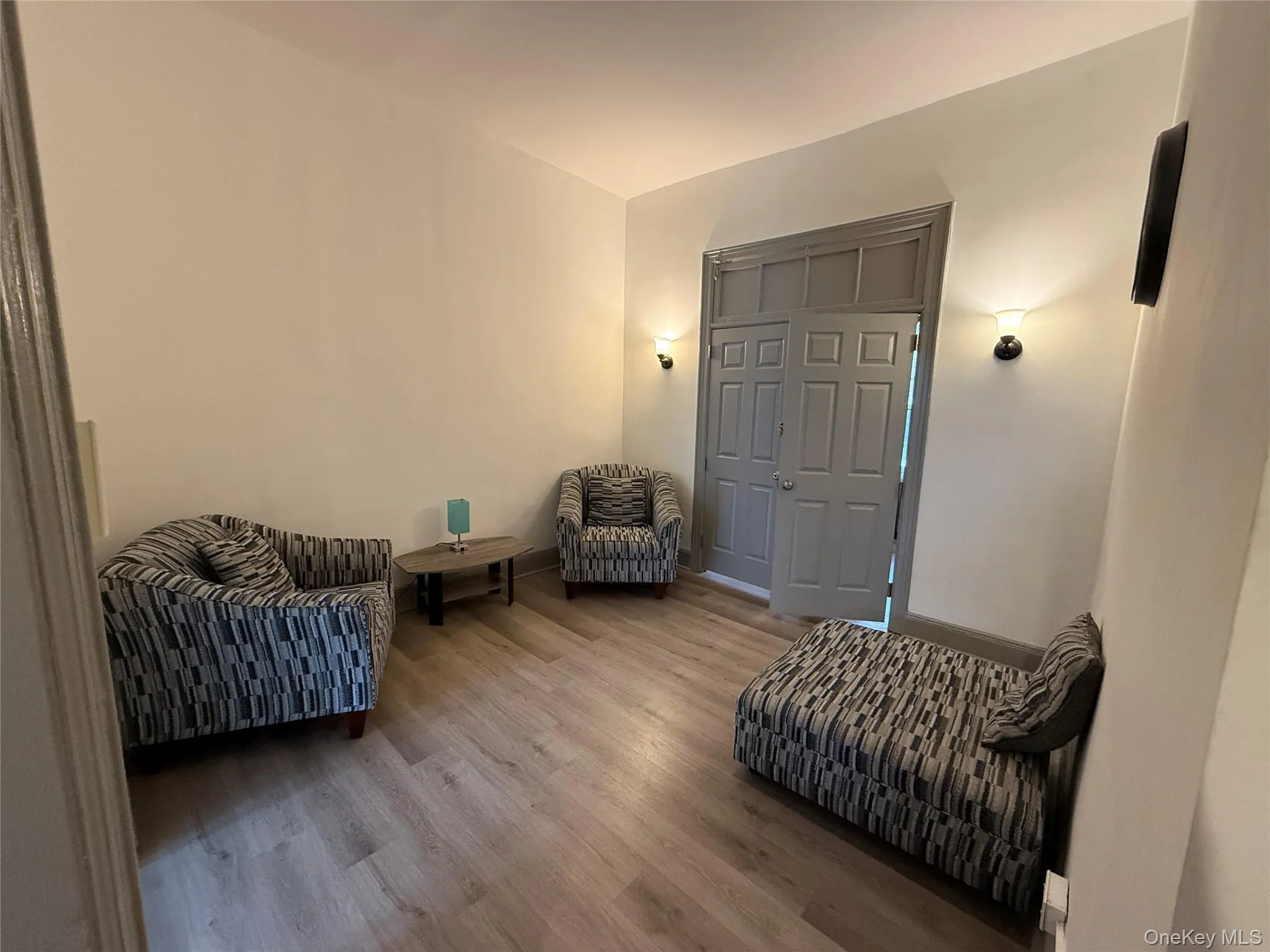 Sitting room with wood finished floors and baseboards Sitting room with wood finished floors and baseboards