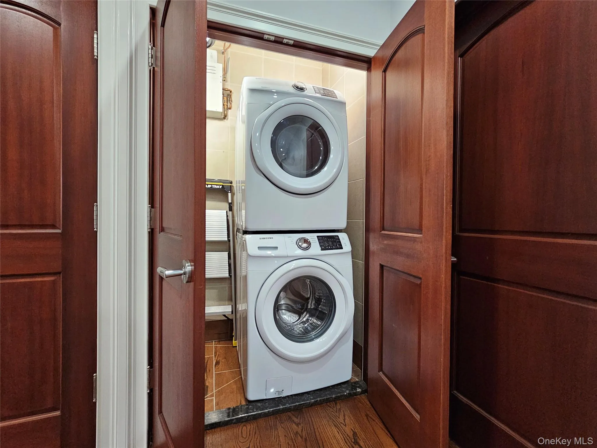 Laundry room featuring stacked washer / dryer Laundry room featuring stacked washer / dryer