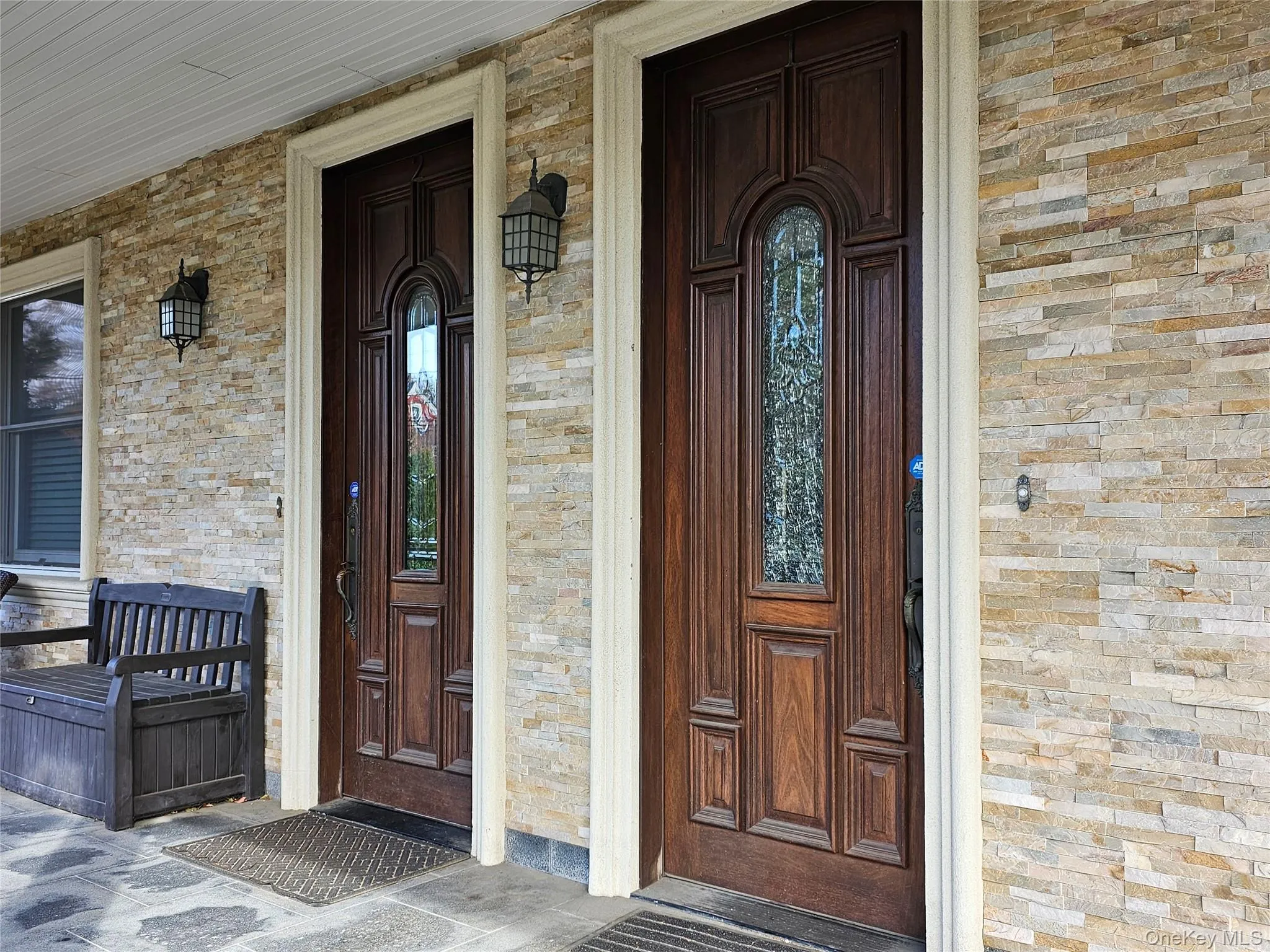 Doorway to property featuring a porch and brick siding Doorway to property featuring a porch and brick siding