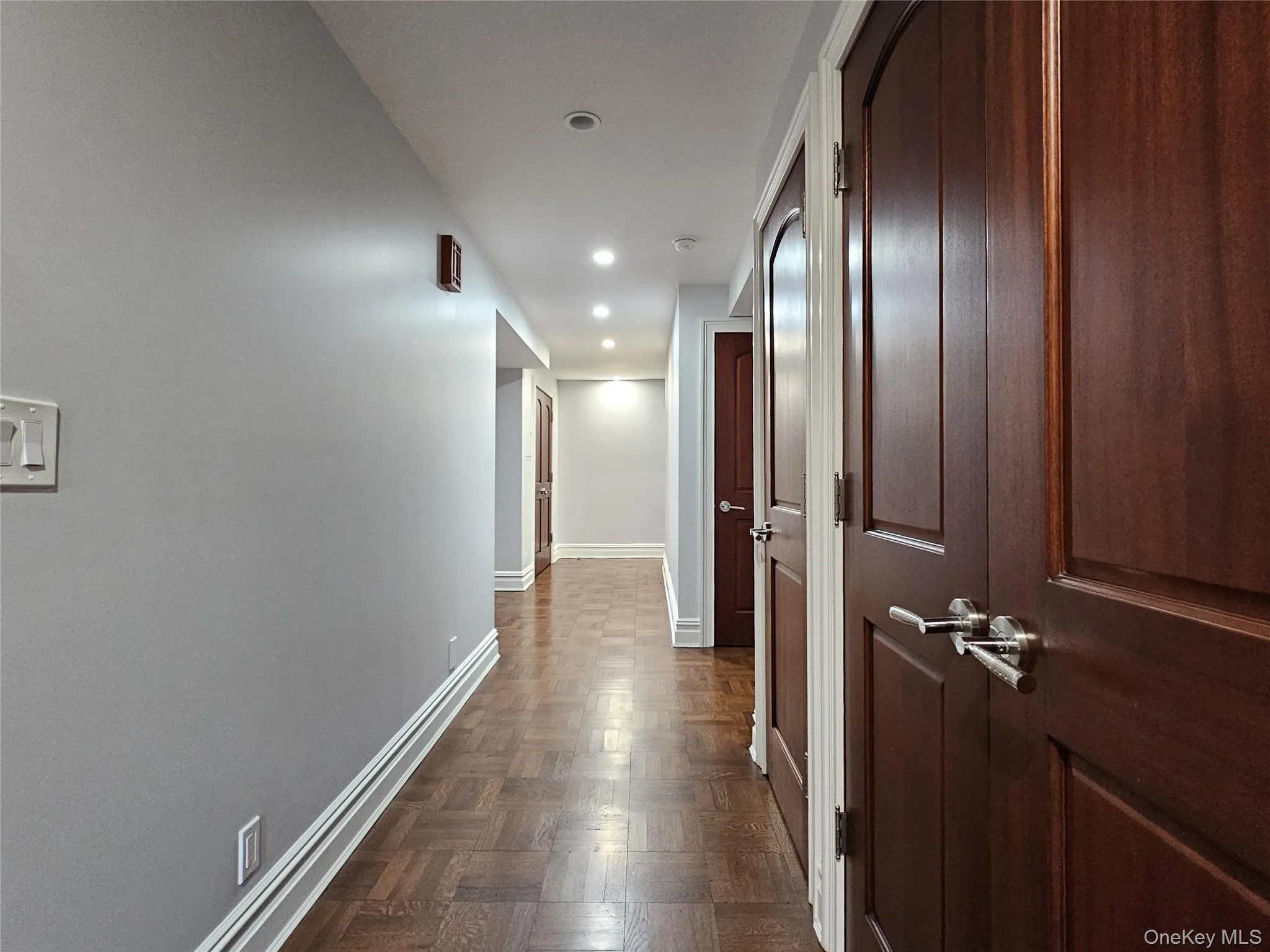 Hallway featuring baseboards and recessed lighting Hallway featuring baseboards and recessed lighting