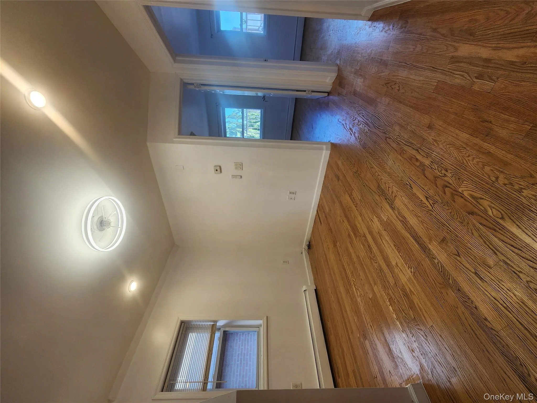 Unfurnished room featuring a baseboard heating unit and dark wood-style flooring Unfurnished room featuring a baseboard heating unit and dark wood-style flooring