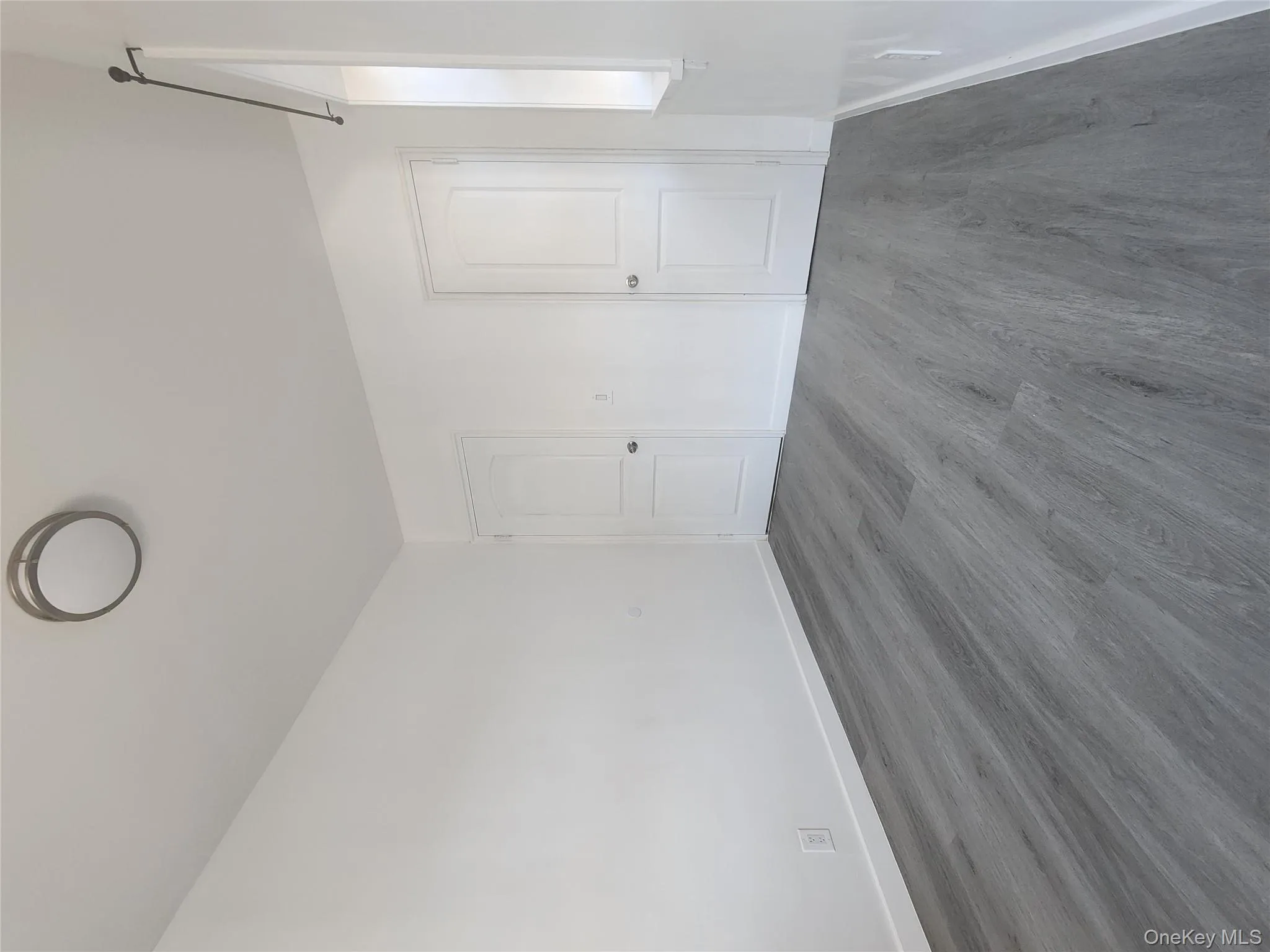 Unfurnished bedroom featuring dark wood finished floors and baseboards Unfurnished bedroom featuring dark wood finished floors and baseboards