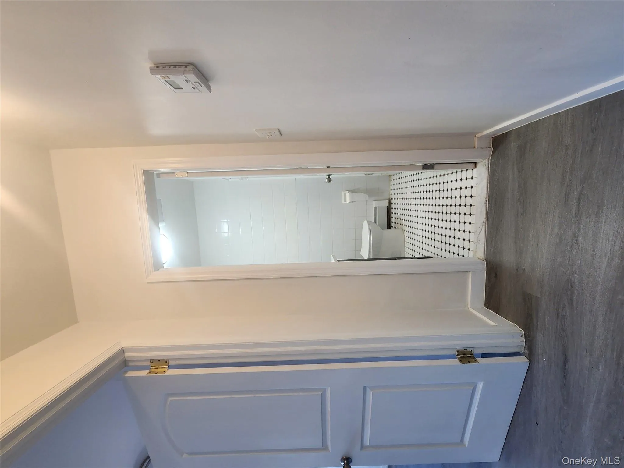 Hallway with dark wood-style floors and baseboard heating Hallway with dark wood-style floors and baseboard heating