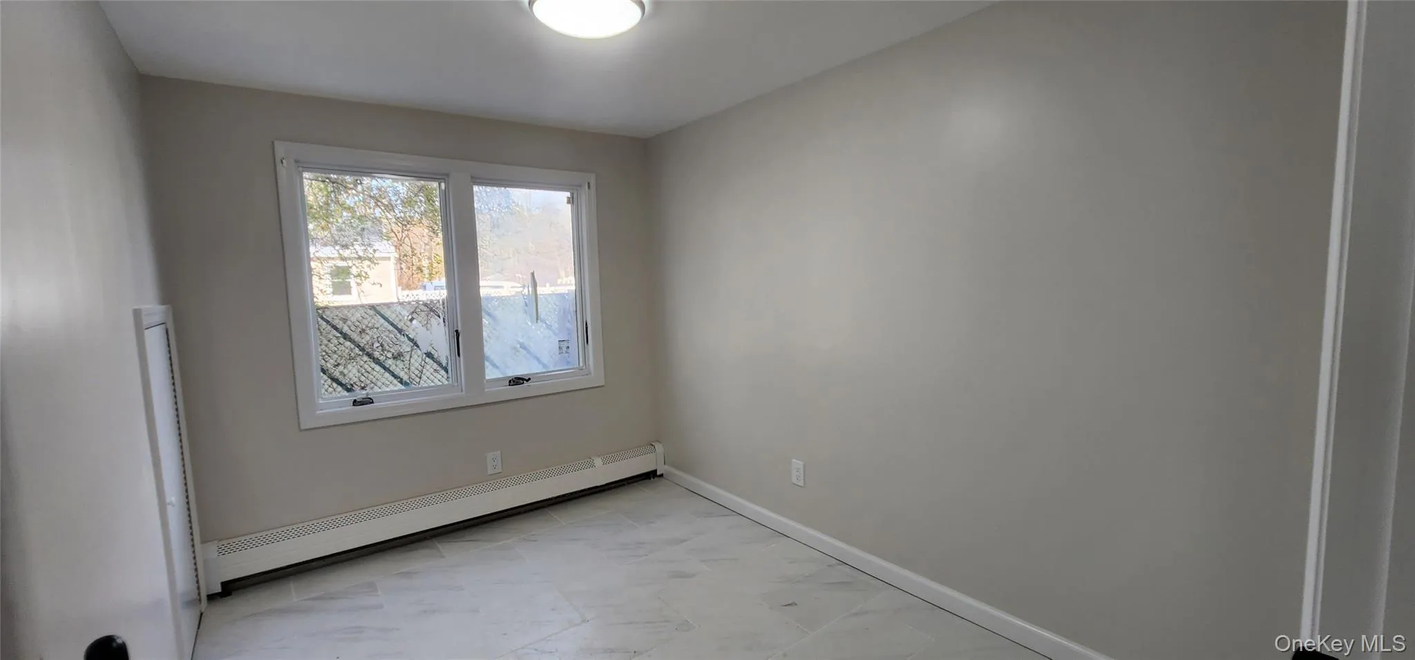 Spare room featuring a baseboard radiator and baseboards Spare room featuring a baseboard radiator and baseboards