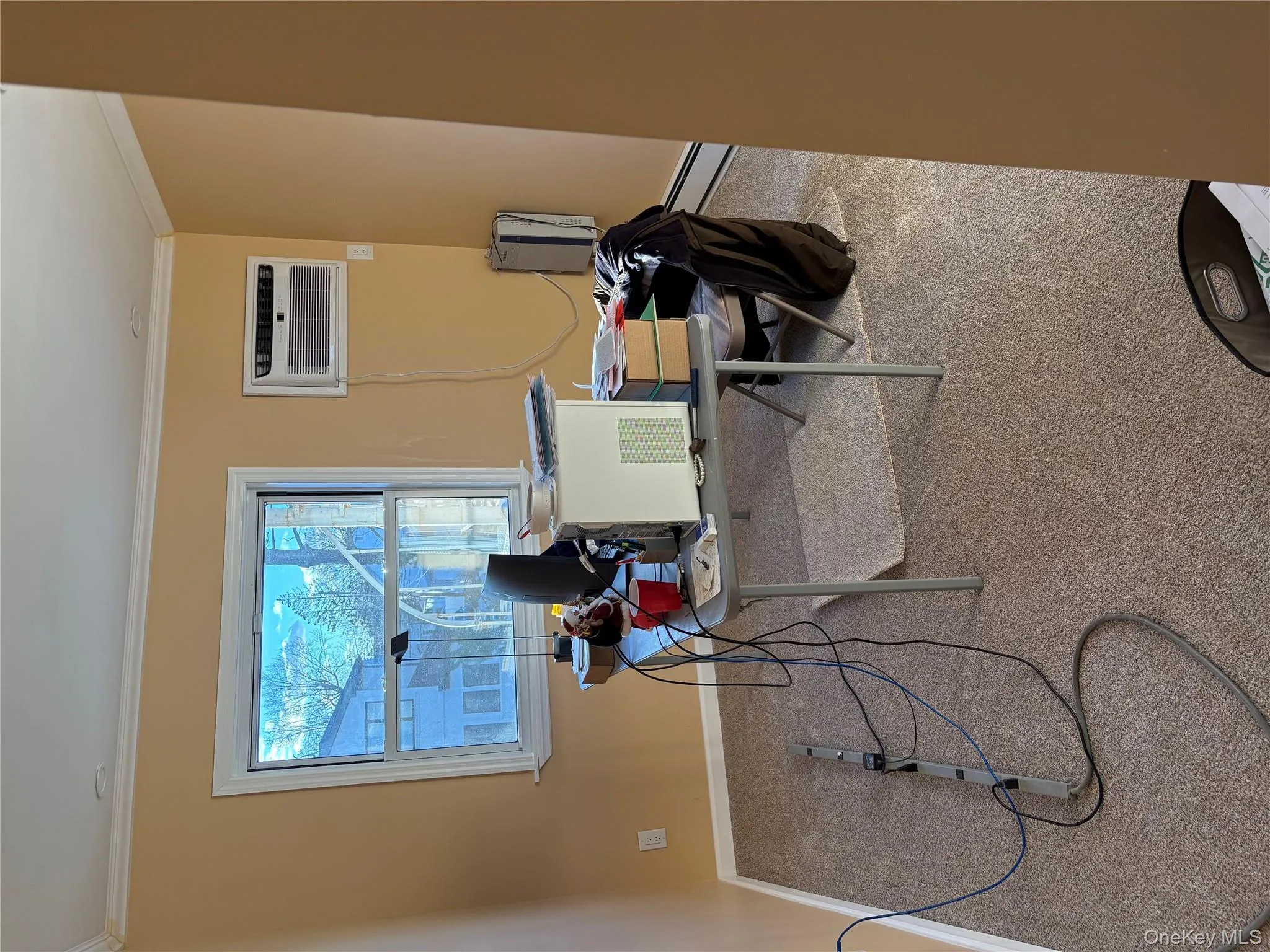 Carpeted office with crown molding and a wall mounted AC Carpeted office with crown molding and a wall mounted AC