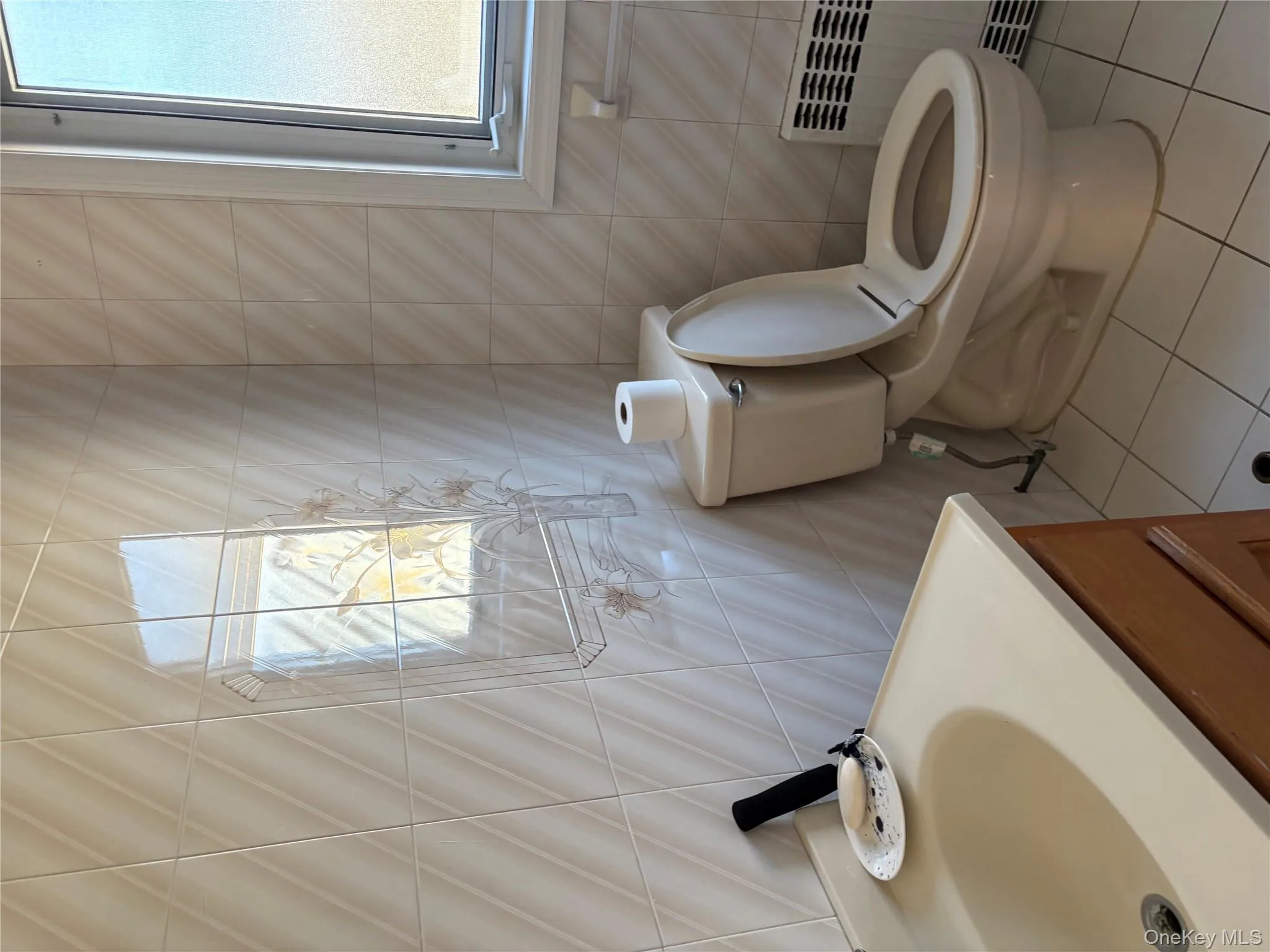 Bathroom featuring radiator heating unit, light tile patterned floors, tile walls, and vanity Bathroom featuring radiator heating unit, light tile patterned floors, tile walls, and vanity