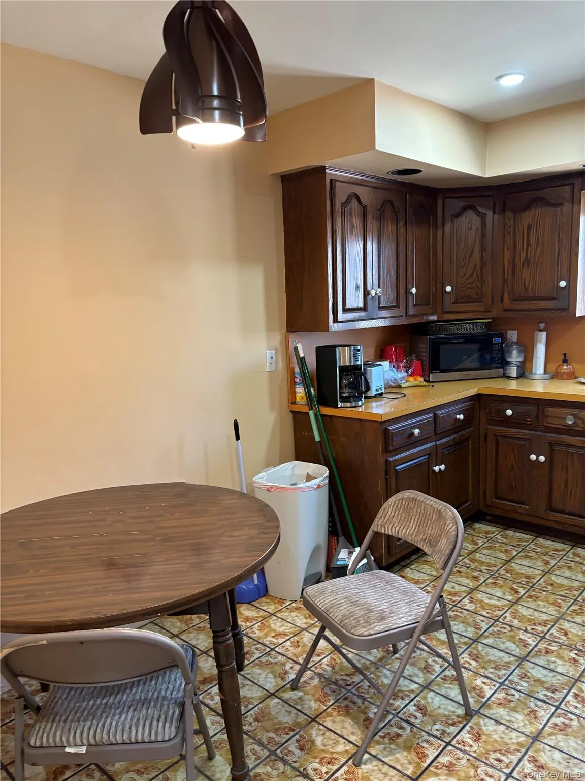 Kitchen with light countertops and dark brown cabinets Kitchen with light countertops and dark brown cabinets