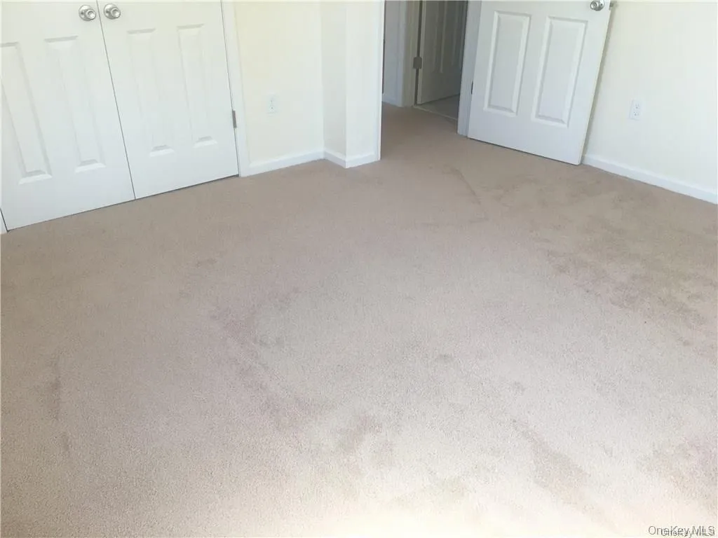 Unfurnished bedroom with baseboards and carpet floors Unfurnished bedroom with baseboards and carpet floors