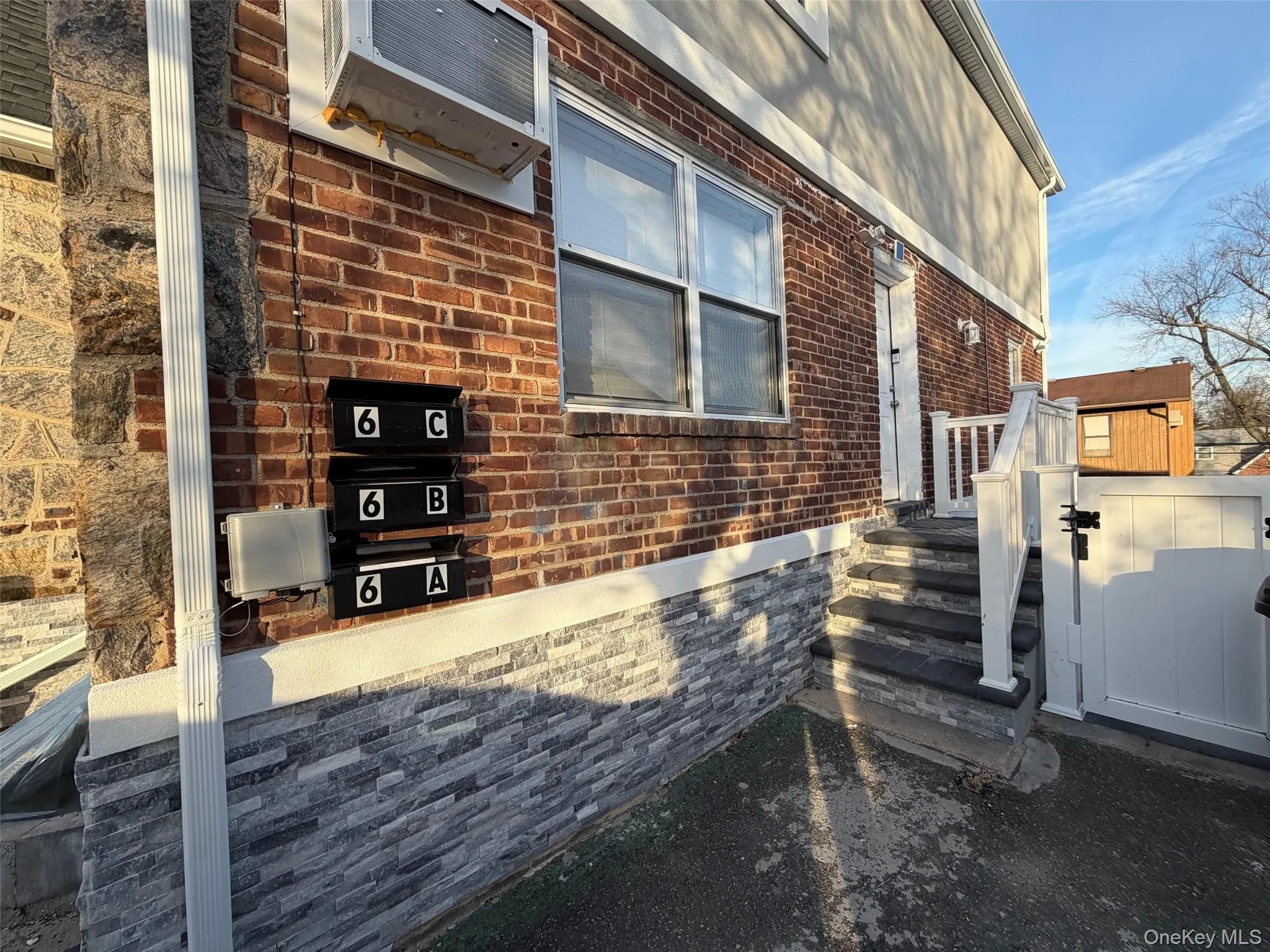 View of home's exterior with a storage shed, brick siding, and a wall mounted air conditioner View of home's exterior with a storage shed, brick siding, and a wall mounted air conditioner