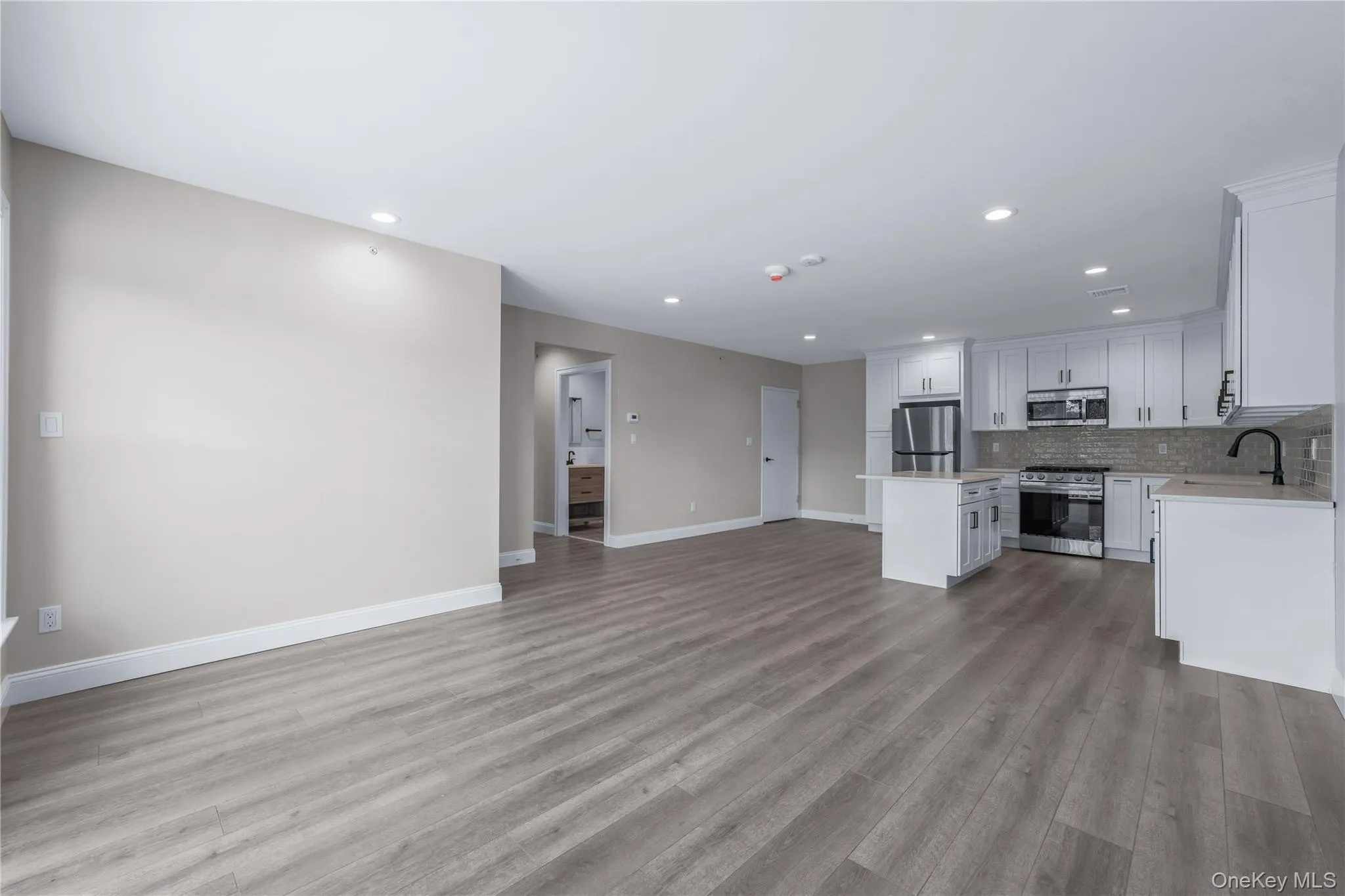 Unfurnished living room with recessed lighting and light wood-style flooring Unfurnished living room with recessed lighting and light wood-style flooring