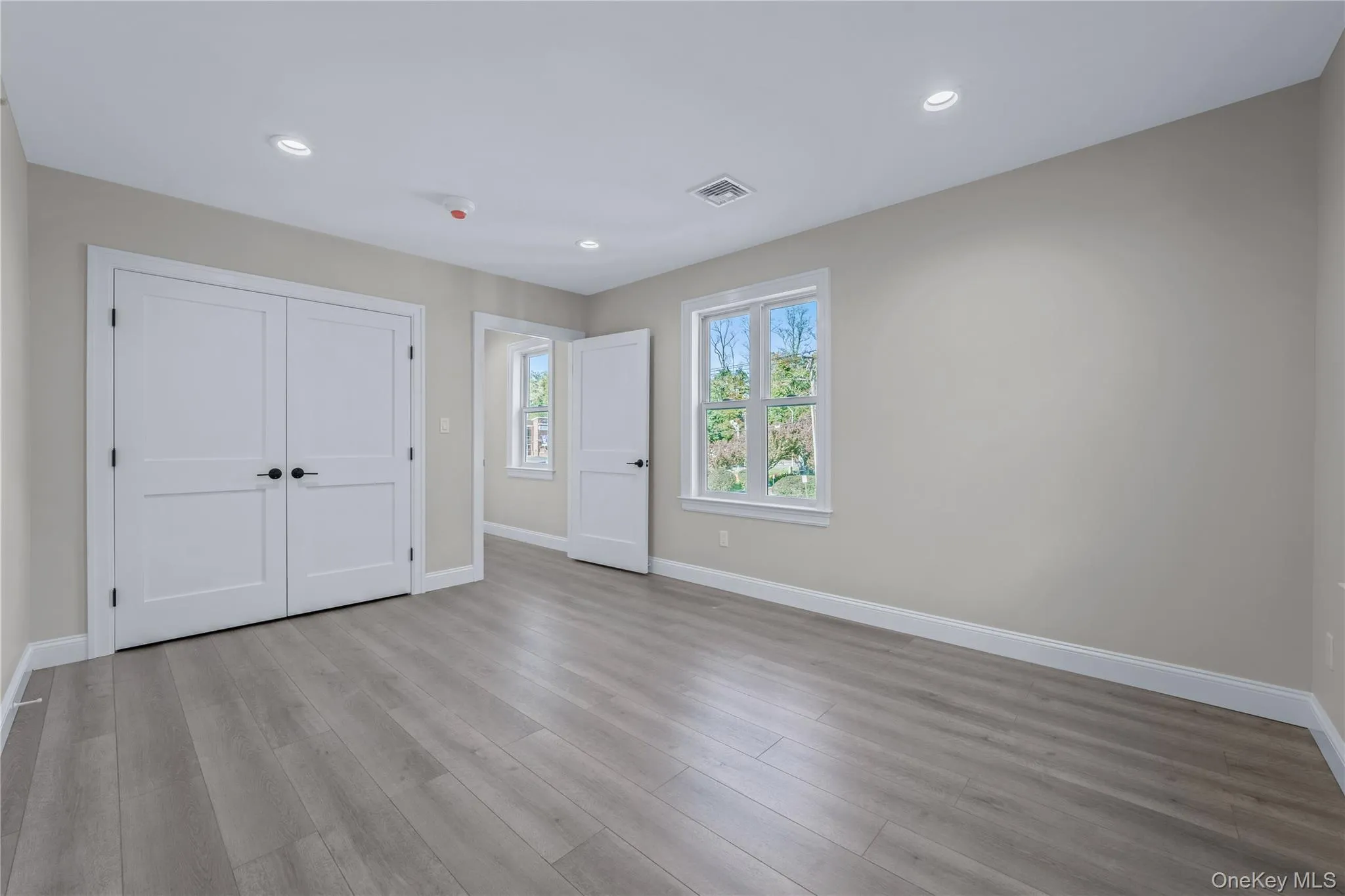 Unfurnished bedroom with light wood finished floors, recessed lighting, and a closet Unfurnished bedroom with light wood finished floors, recessed lighting, and a closet