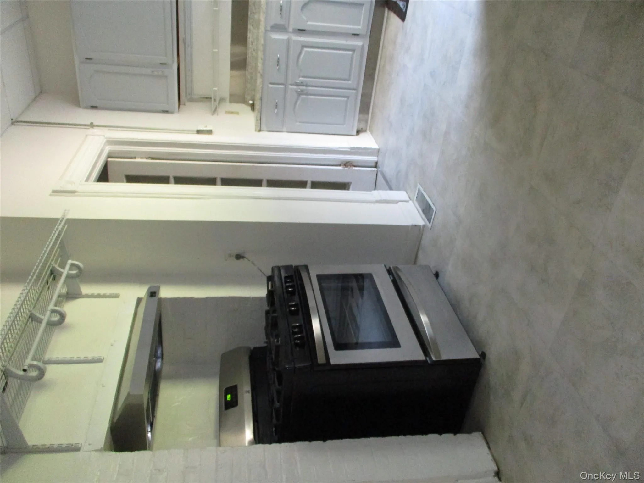 Kitchen with stainless steel range, exhaust hood, and gray cabinets Kitchen with stainless steel range, exhaust hood, and gray cabinets