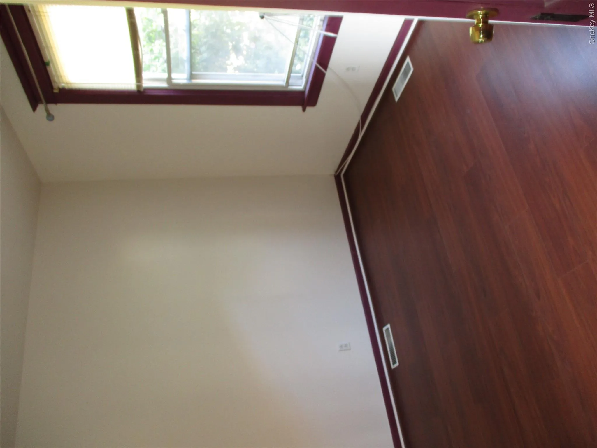 Empty room featuring dark wood finished floors and baseboards Empty room featuring dark wood finished floors and baseboards