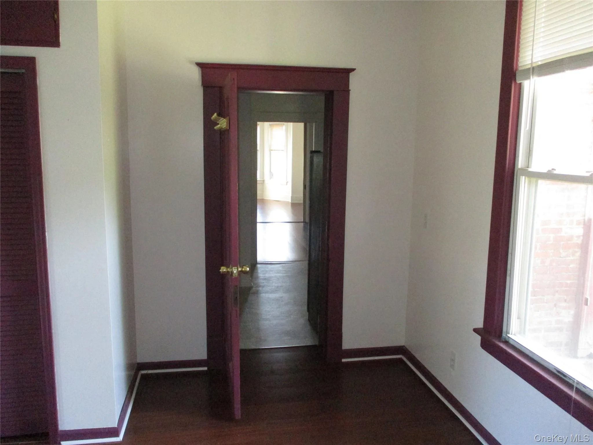 Hall with plenty of natural light and dark wood-type flooring Hall with plenty of natural light and dark wood-type flooring