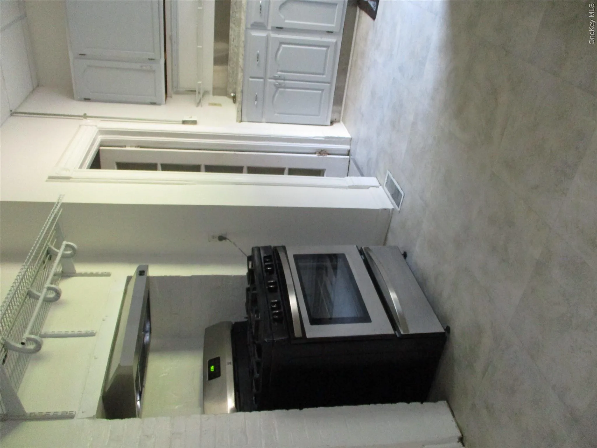 Kitchen with stainless steel range, exhaust hood, and gray cabinets Kitchen with stainless steel range, exhaust hood, and gray cabinets