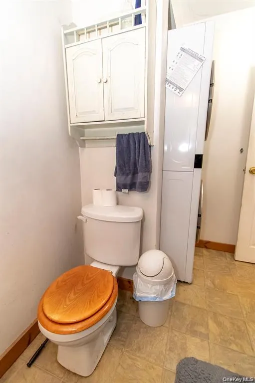 Bathroom with baseboards and toilet Bathroom with baseboards and toilet