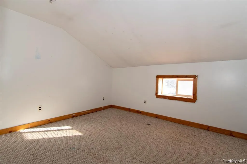 Bonus room with lofted ceiling and carpet flooring Bonus room with lofted ceiling and carpet flooring
