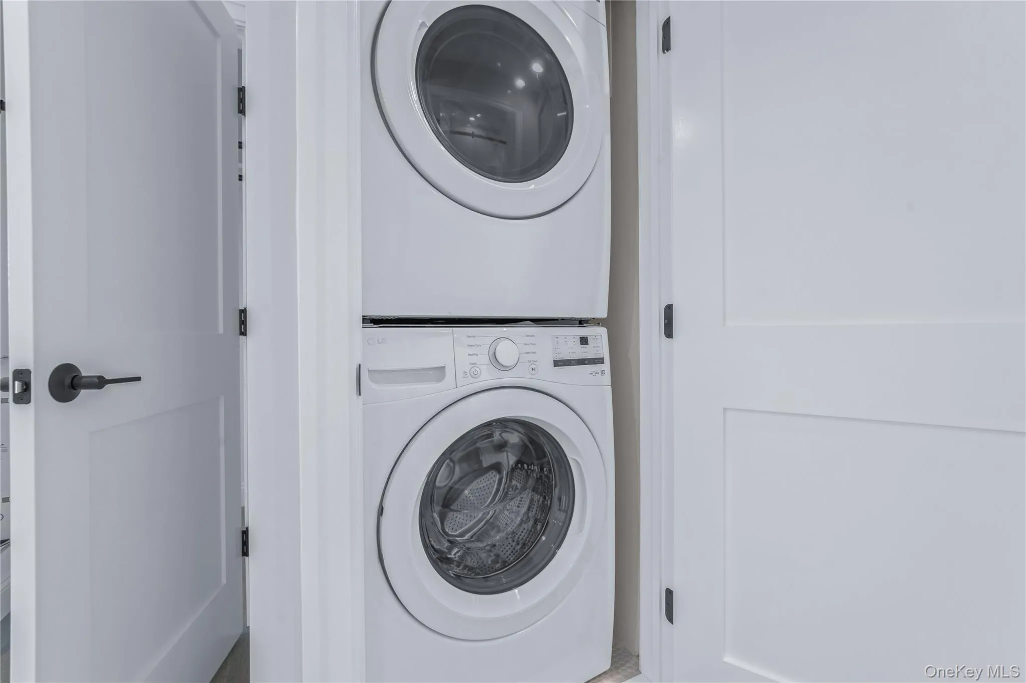 Laundry room with stacked washer and clothes dryer Laundry room with stacked washer and clothes dryer