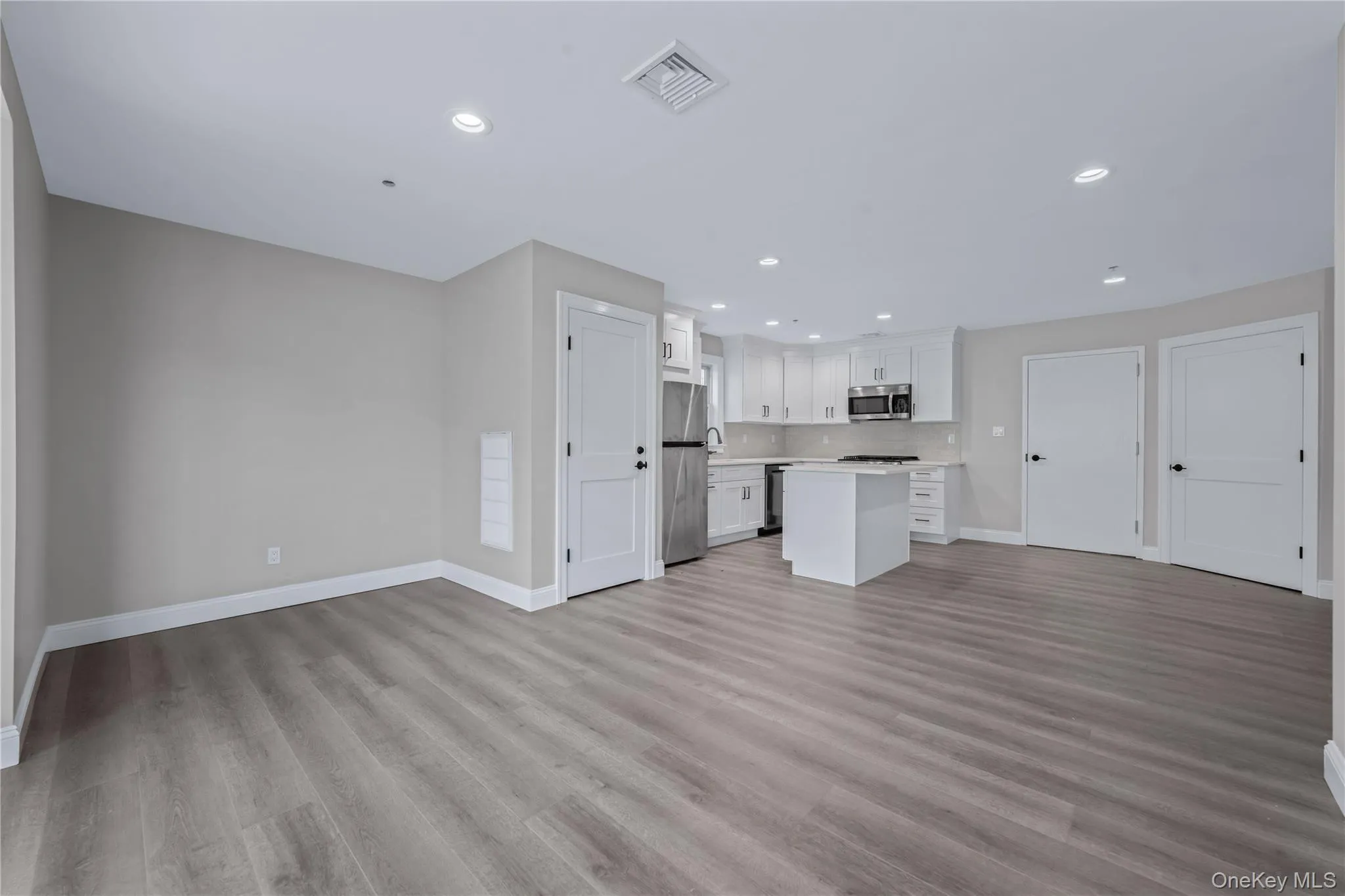 Unfurnished living room featuring recessed lighting and light wood-type flooring Unfurnished living room featuring recessed lighting and light wood-type flooring
