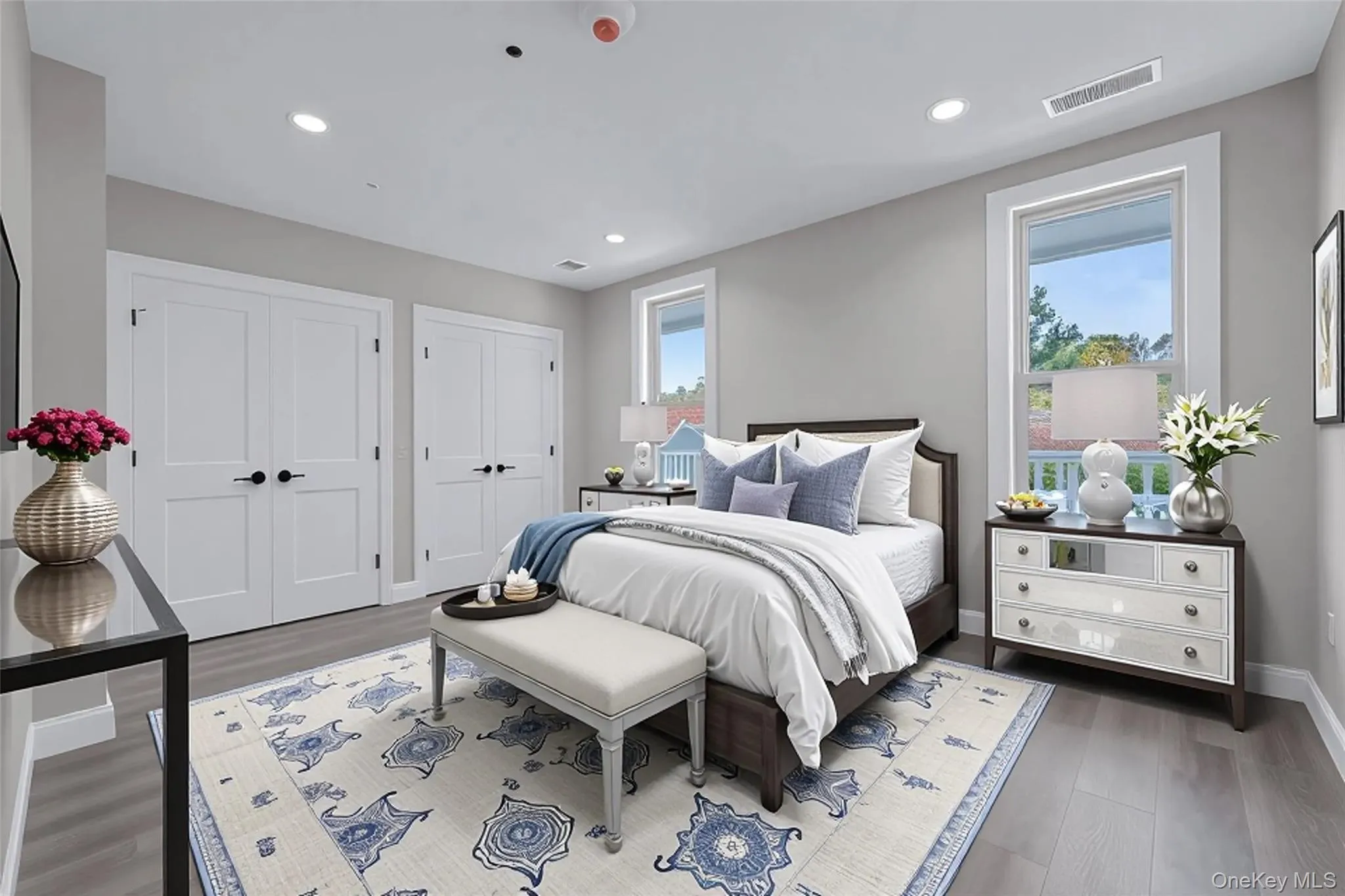Bedroom featuring multiple closets, wood finished floors, and recessed lighting Bedroom featuring multiple closets, wood finished floors, and recessed lighting