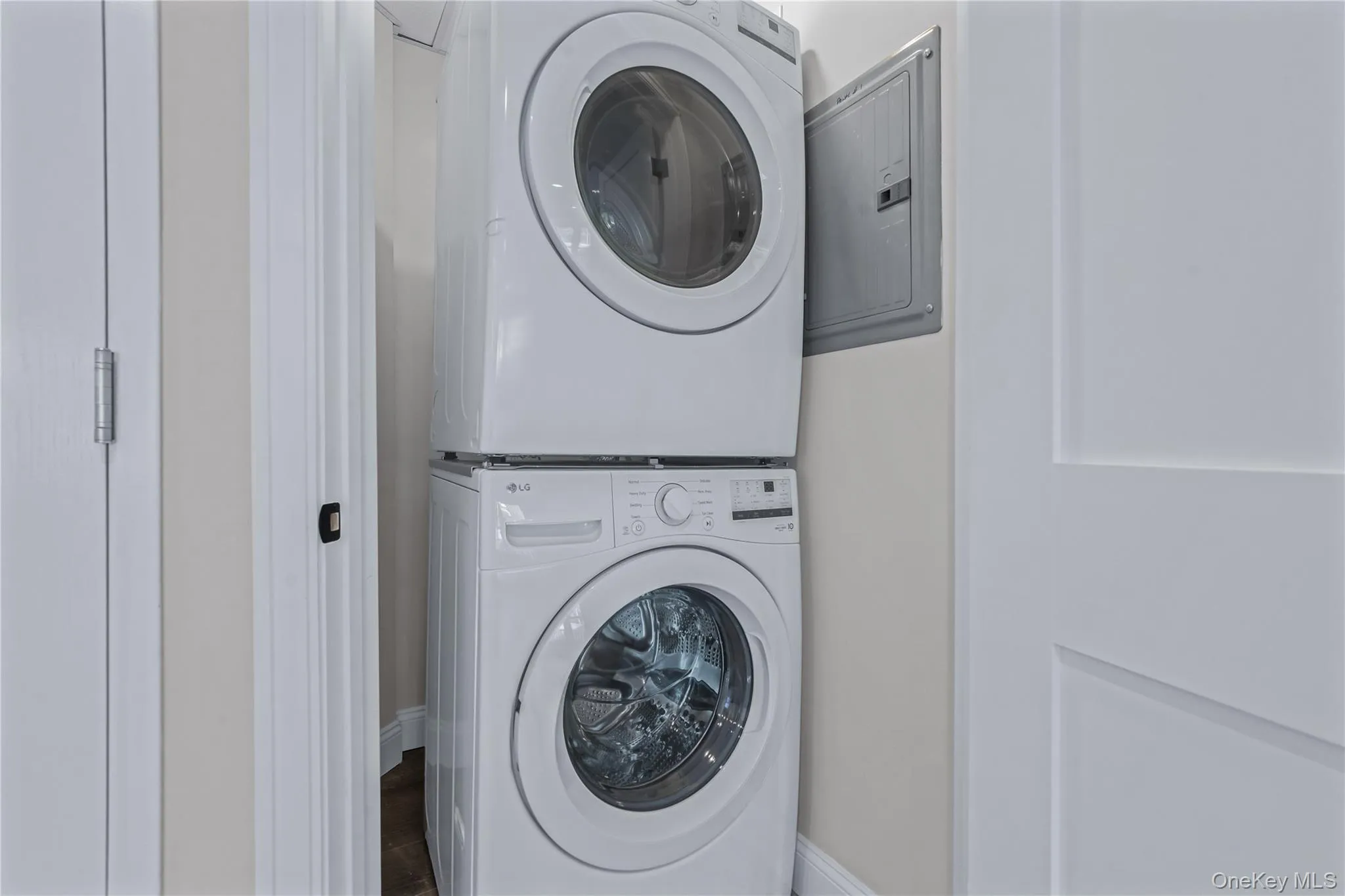 Washroom with electric panel and stacked washer / drying machine Washroom with electric panel and stacked washer / drying machine