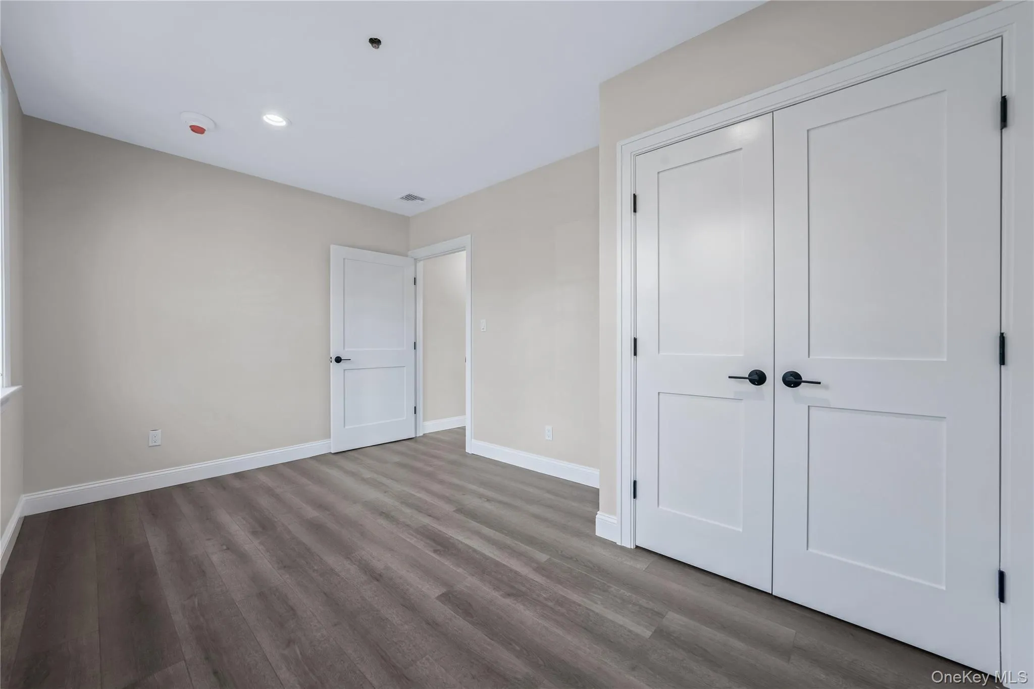 Unfurnished bedroom featuring wood finished floors, a closet, and recessed lighting Unfurnished bedroom featuring wood finished floors, a closet, and recessed lighting