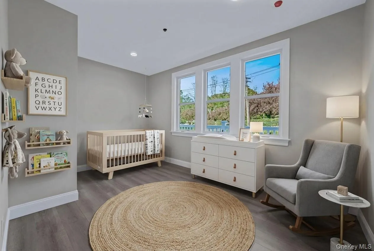 Bedroom with wood finished floors and a crib Bedroom with wood finished floors and a crib