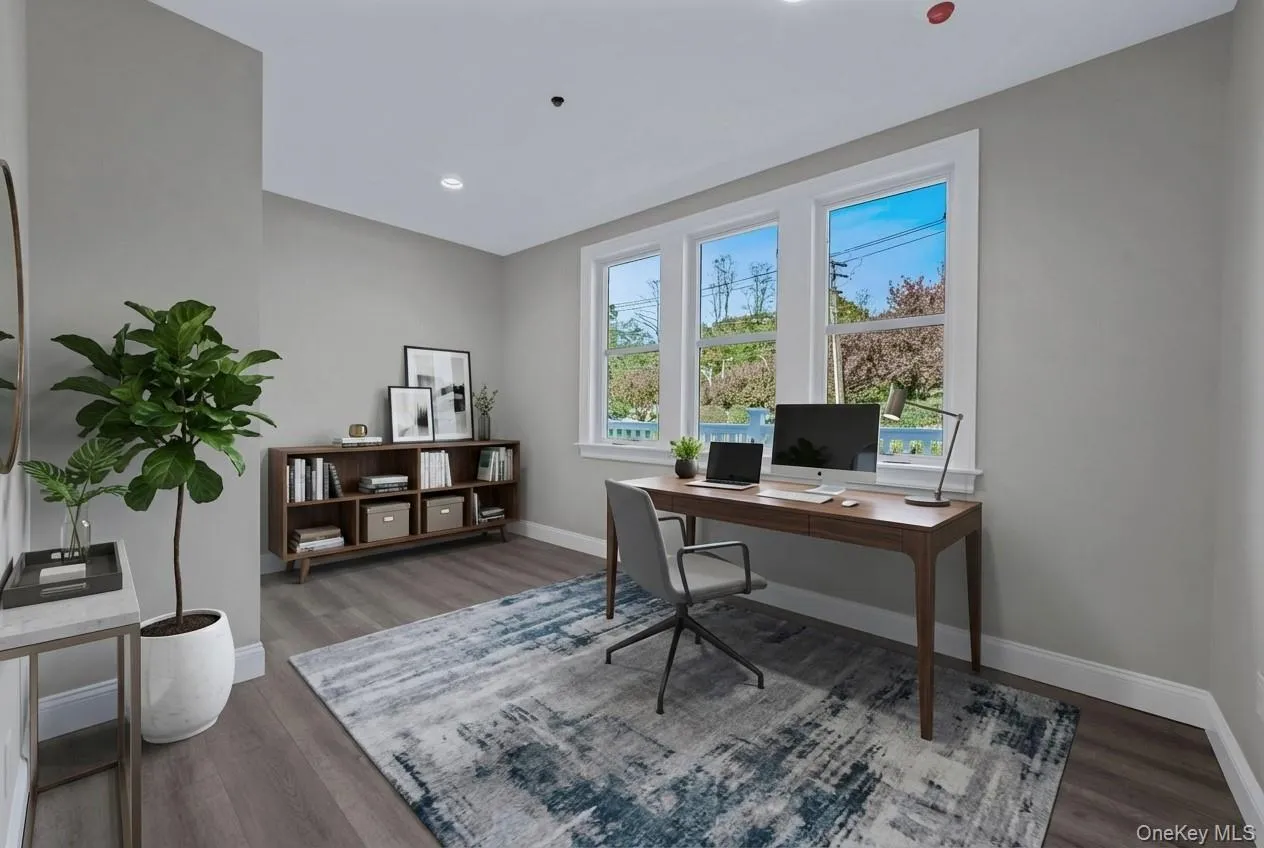 Office space with dark wood-style flooring Office space with dark wood-style flooring
