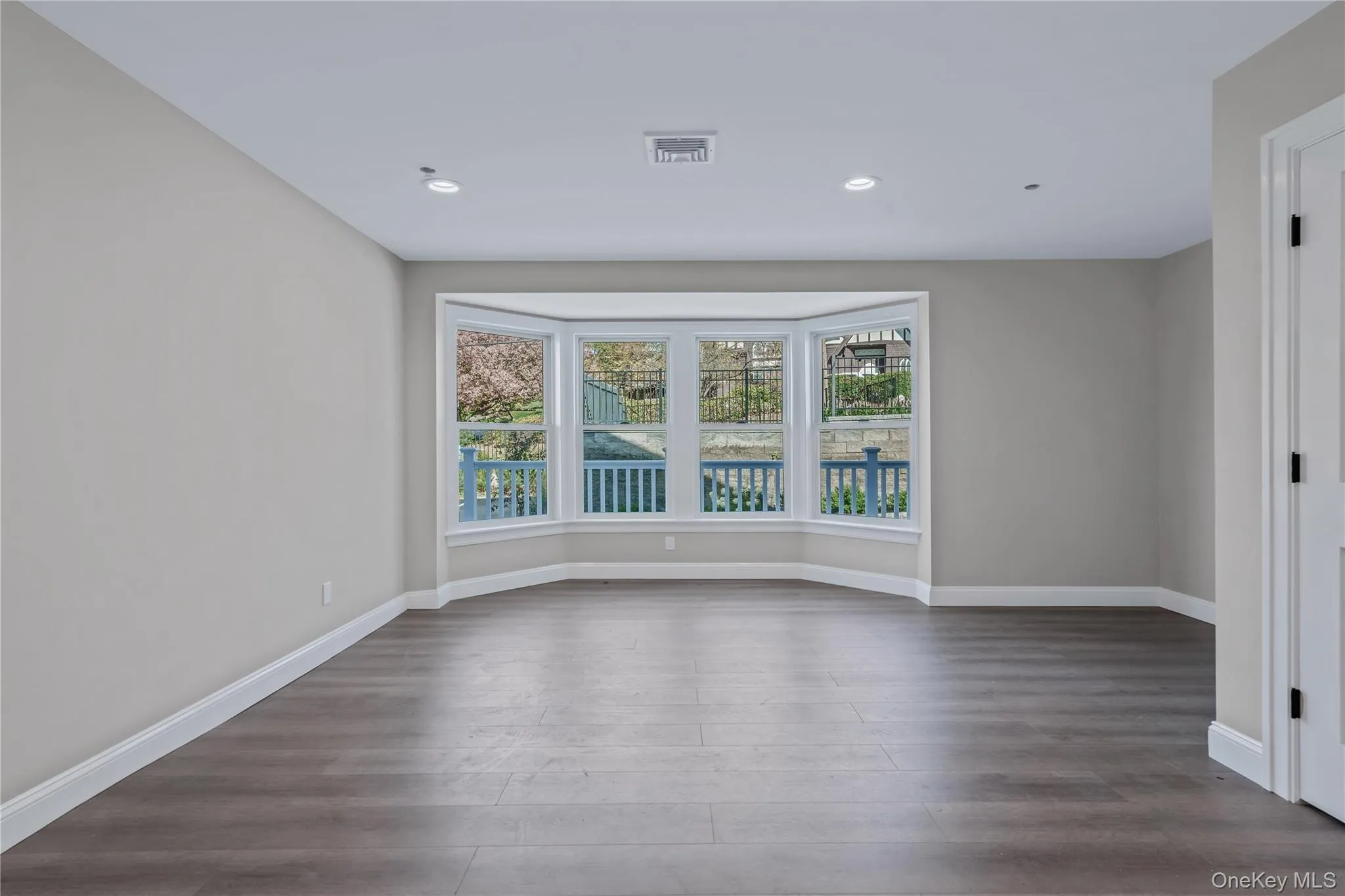 Spare room featuring wood finished floors and recessed lighting Spare room featuring wood finished floors and recessed lighting